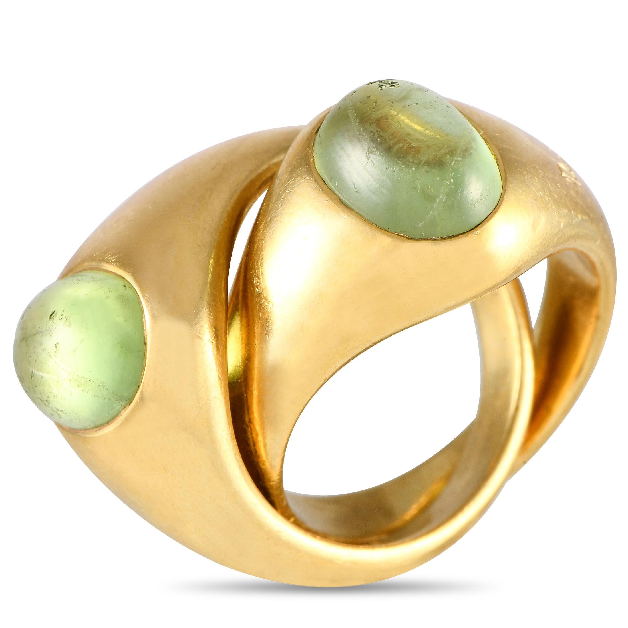 A duo of high-polish yellow gold ring, each punctuated by an oval peridot cabochon, unite to create a single statement band. This stunner from the Milanese brand is perfect for day and night wear. The ring's top dimensions measure 16mm x 20mm.This