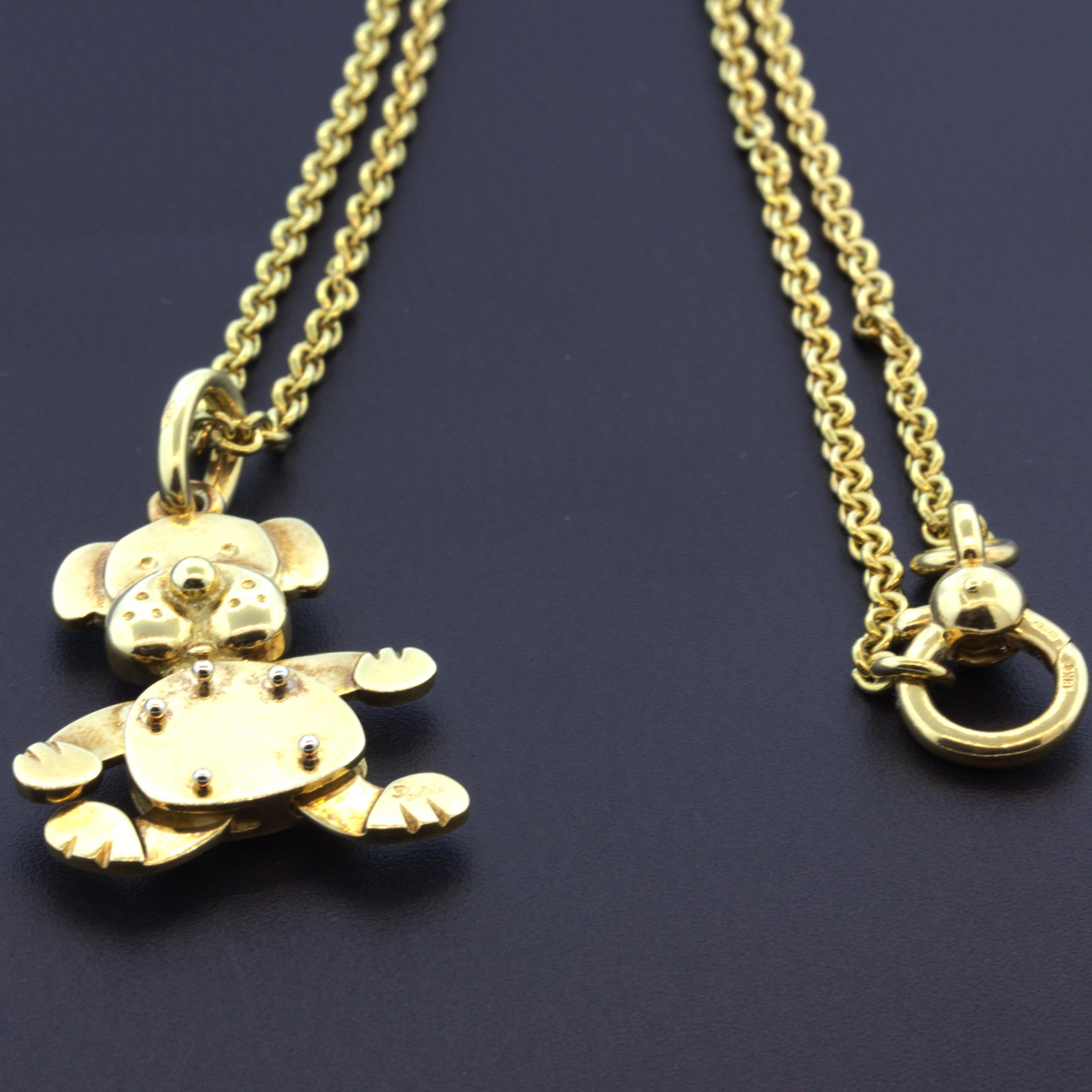 A stylish pendant from Italian designer Pomellato. It features an 18k yellow gold dog with hands and feet that move freely. It comes with an original 18k yellow gold necklace by Pomellato as well. Made in 18k yellow gold and ready to be