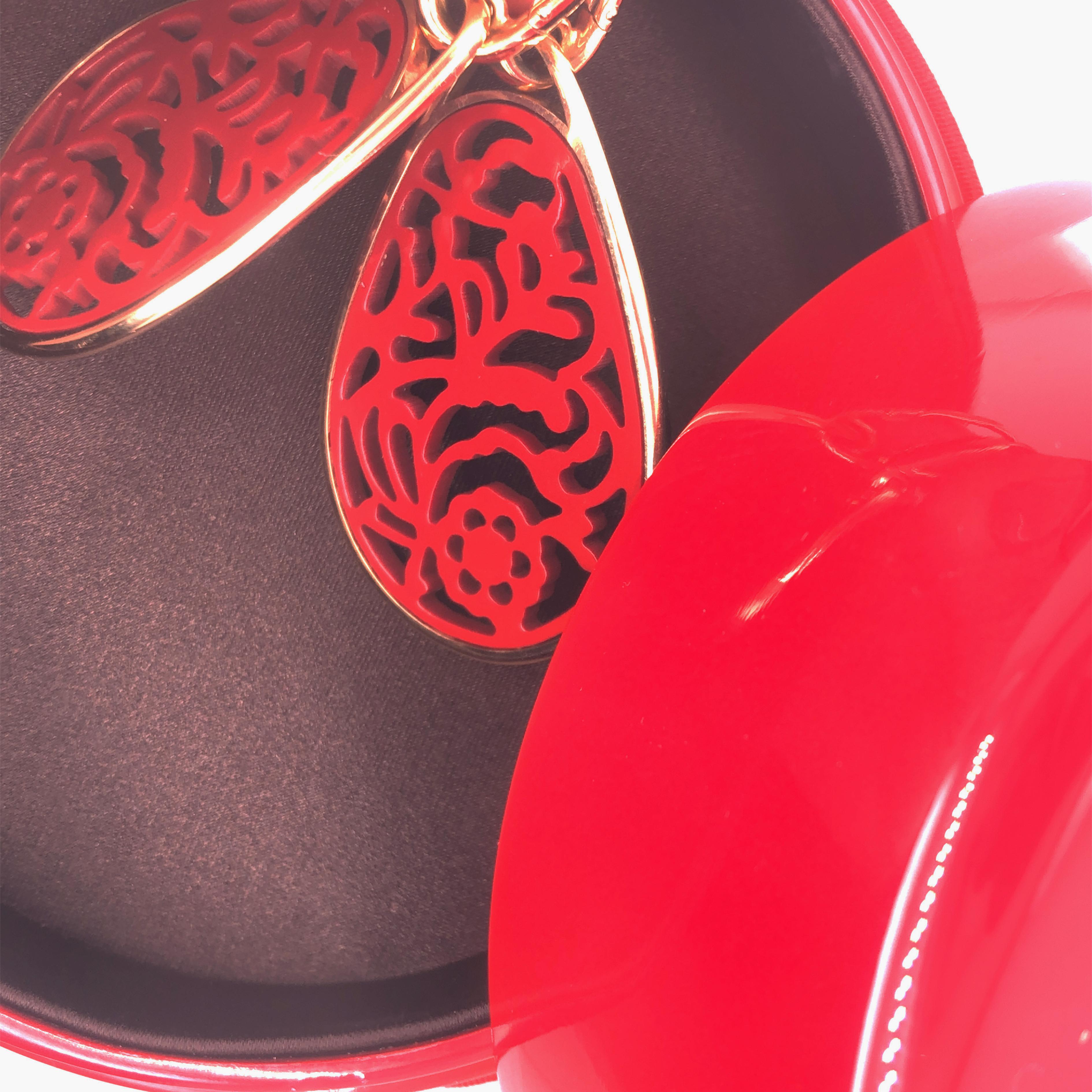 A Pomellato Iconic Timeless Jewel: Lightweight and striking, these Drop Earrings accentuate the delicacy of Rose Gold with an Inlaid Floral Pattern in Lacquer Red. Rhodoid is a special type of cellulose acetate, a natural compound obtained by