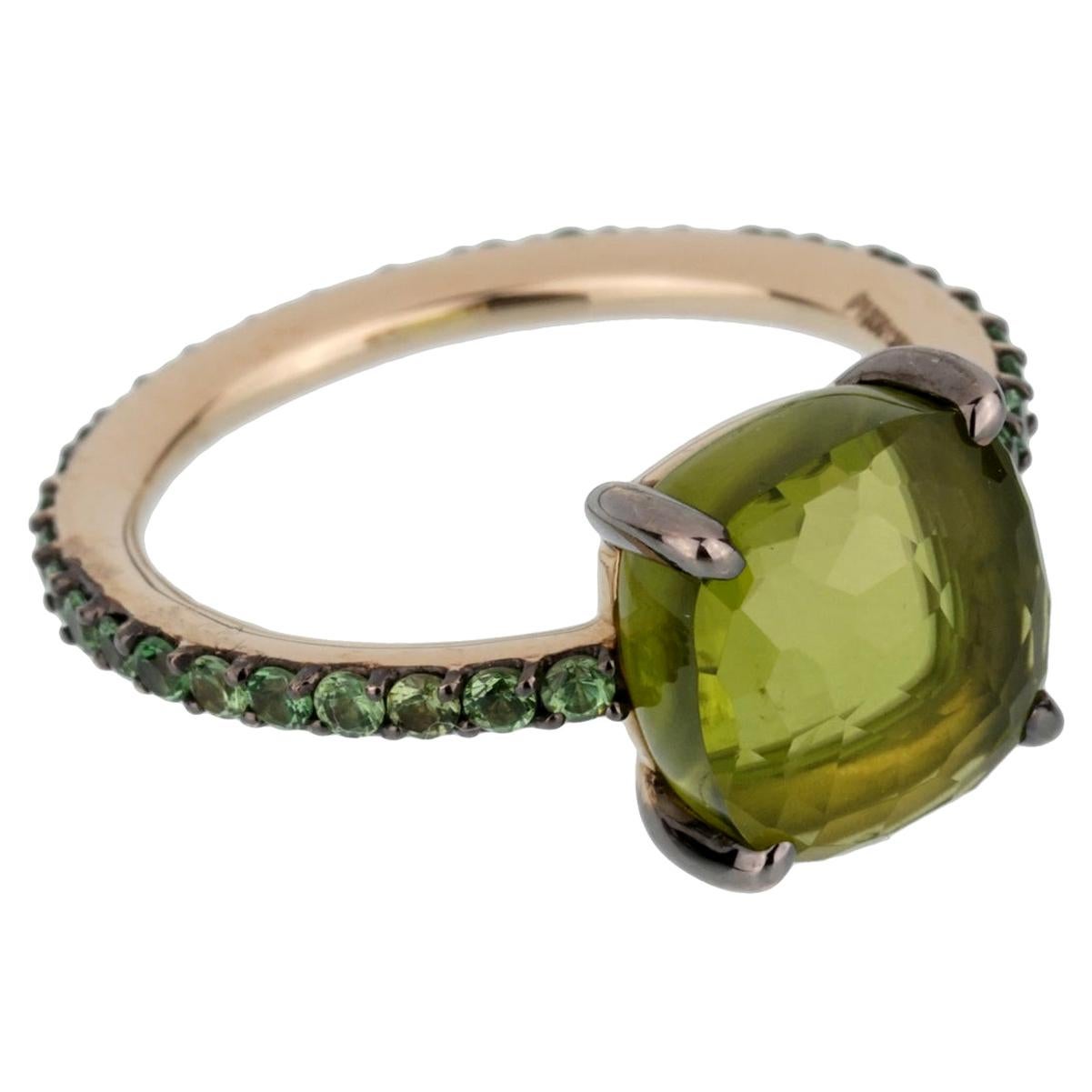 A fabulous brand new Pomellato cocktail ring showcasing a 3.56ct Peridot surrounded by .61ct of brilliant round tsavorite garnets set in 18k white gold. The ring size is 6.25.

Pomellato Retail Price: $10,500
Sku:2445
