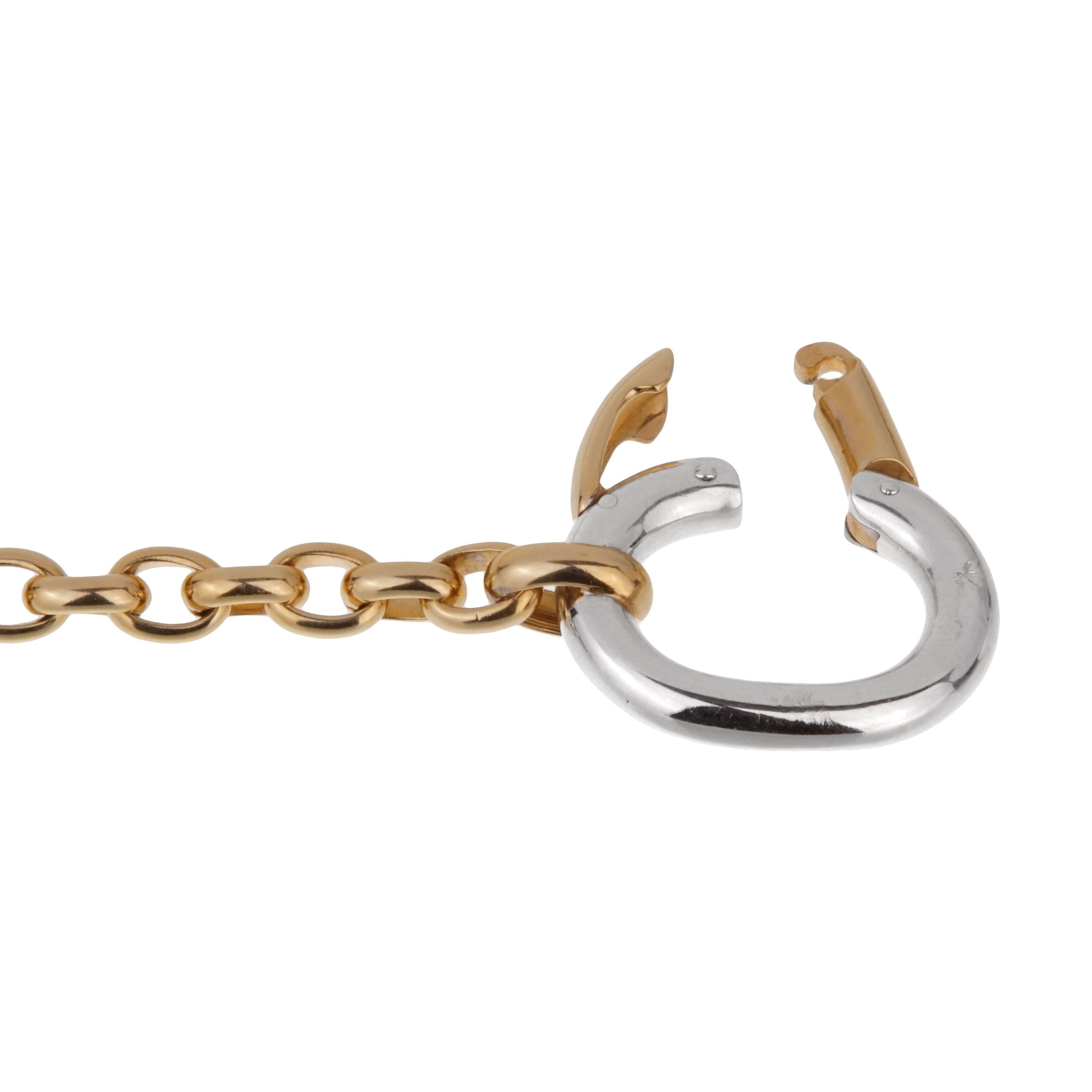 A chic Pomellato chain link necklace featuring a yellow gold chain link finished with an oversized white gold clasp in 18k gold. The necklace measures 20