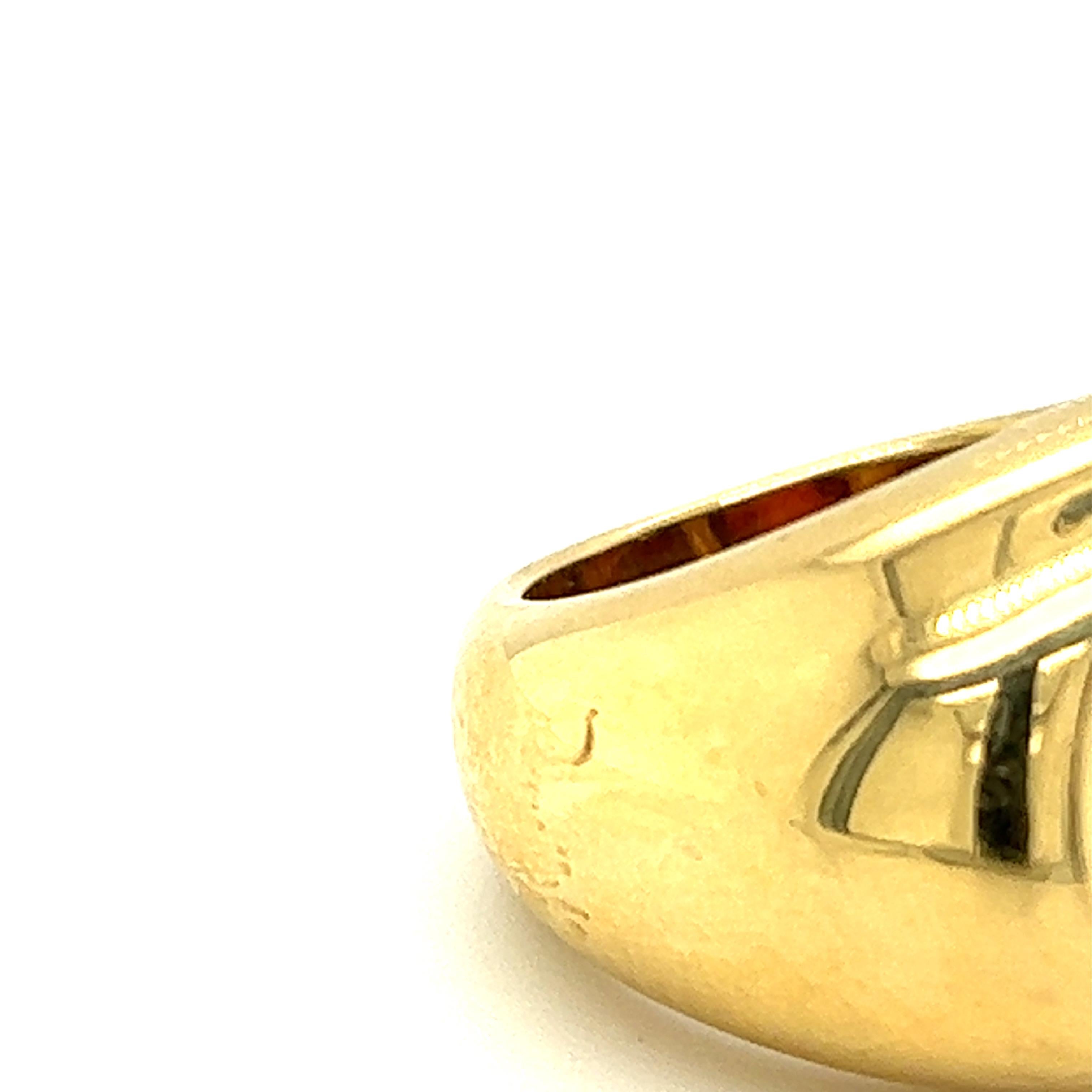 One Citrine Carved Disc Ring in 18 karat yellow gold by Pomellato features one 11.5x2.55mm oval-shaped polished citrine in a bezel setting. There is a small blemish in on the side of the ring (see photo), but metal is intact. 
The ring is a finger