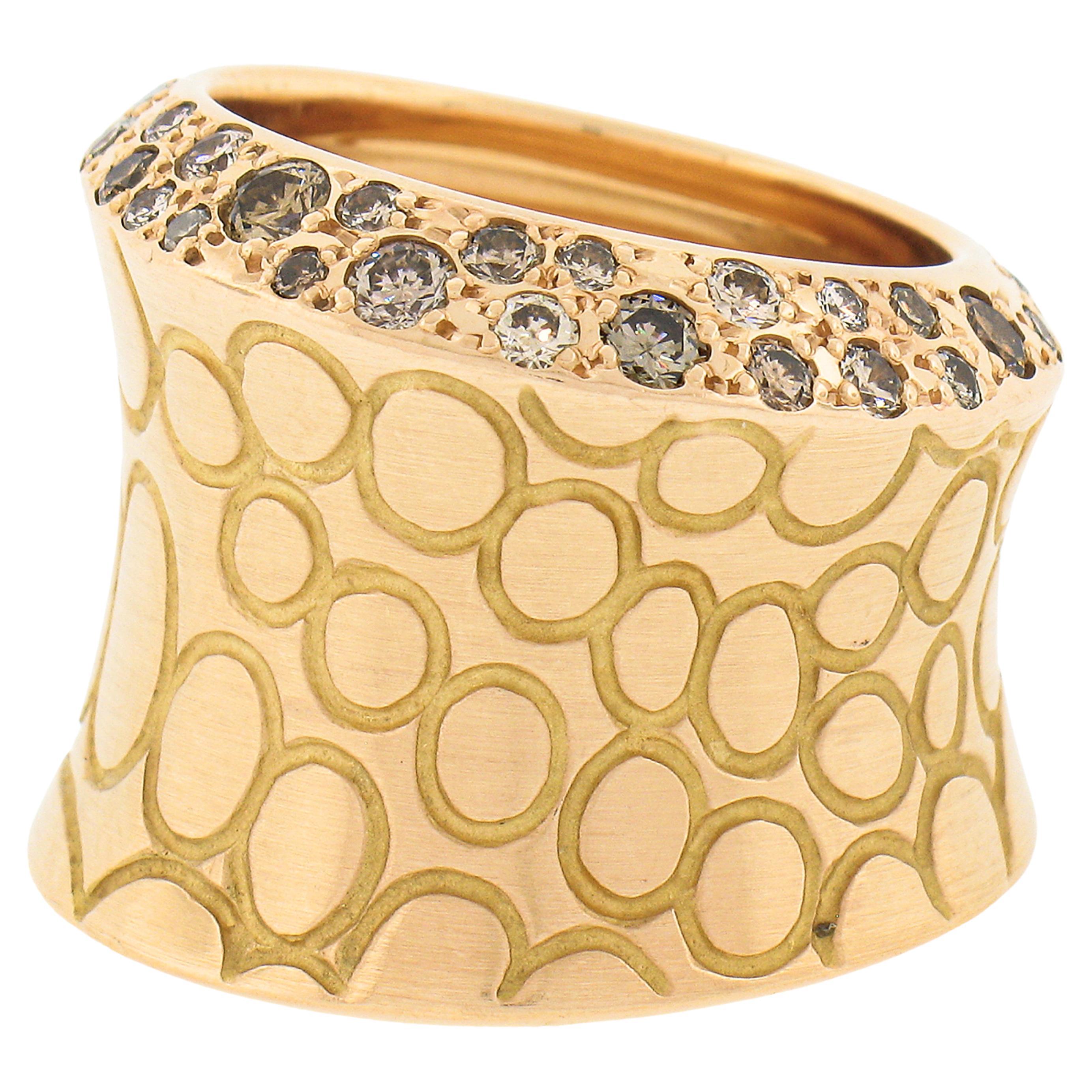This bold diamond cocktail band ring by Pomellato is crafted in Italy from solid 18k rose gold and features fine quality fancy brown and champagne diamonds, pavé set throughout the edges of one side of the wide concave design. The bubble patterns