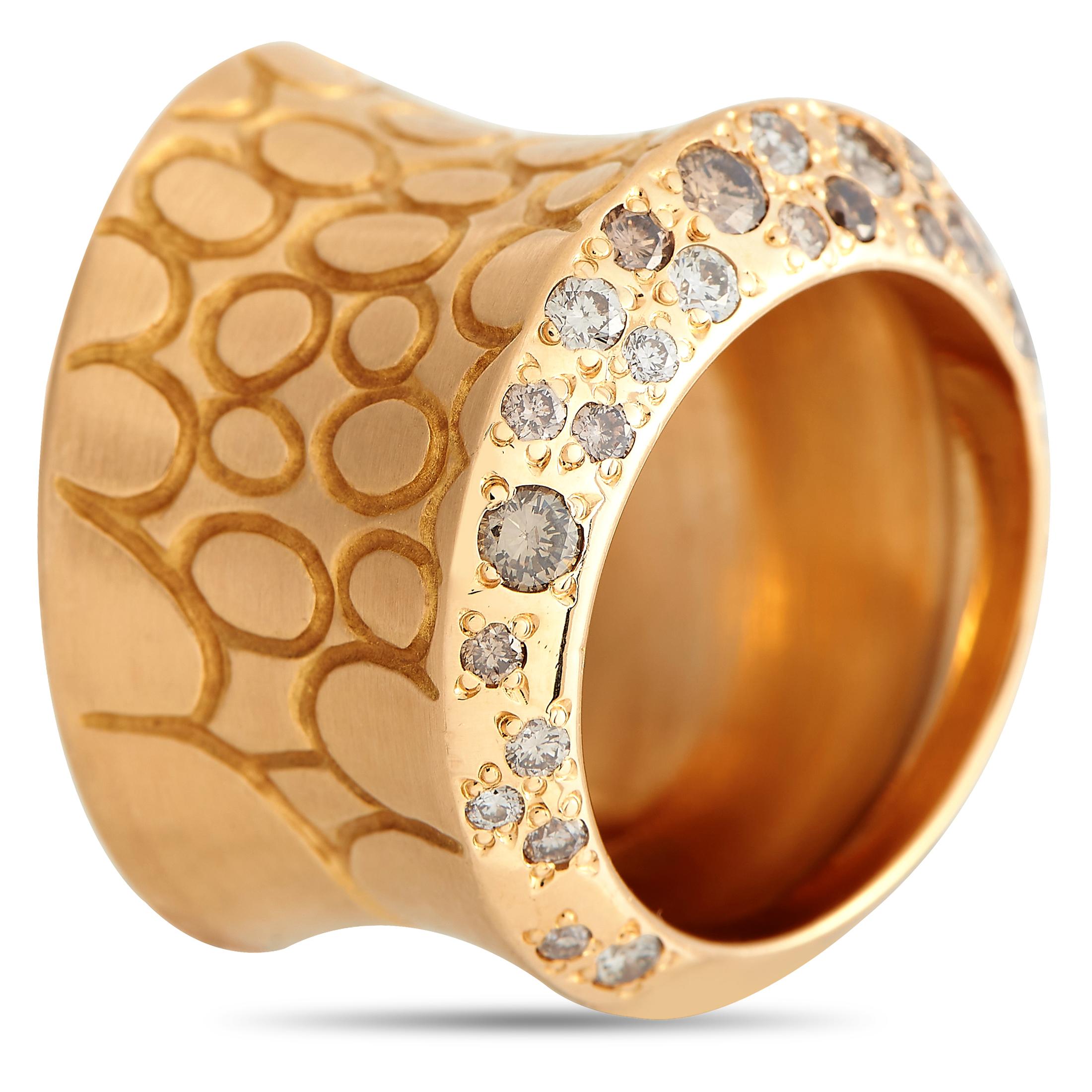 Geometry, texture, and luster are combined to create the eye-catching appeal of this unconventional statement ring. An ingenious creation by Pomellato, the ring features a rose gold band measuring 15mm wide finished with engraved circular motifs and