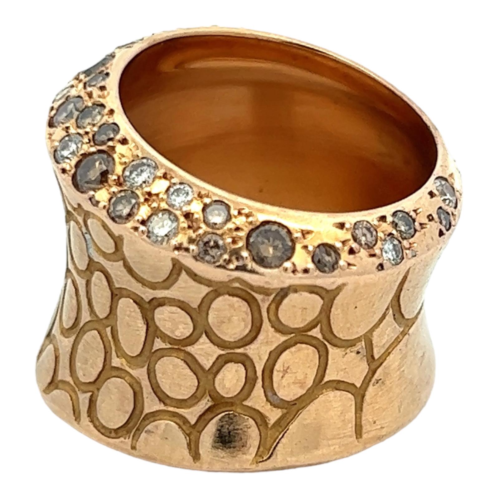 Sophisticated and high fashion wide band ring by Pomellato. The Cocco ring sparkles with round brilliant white and champagne diamonds weighing .90 carat total weight. The graduated band features an array of circles carved 18 karat rose gold