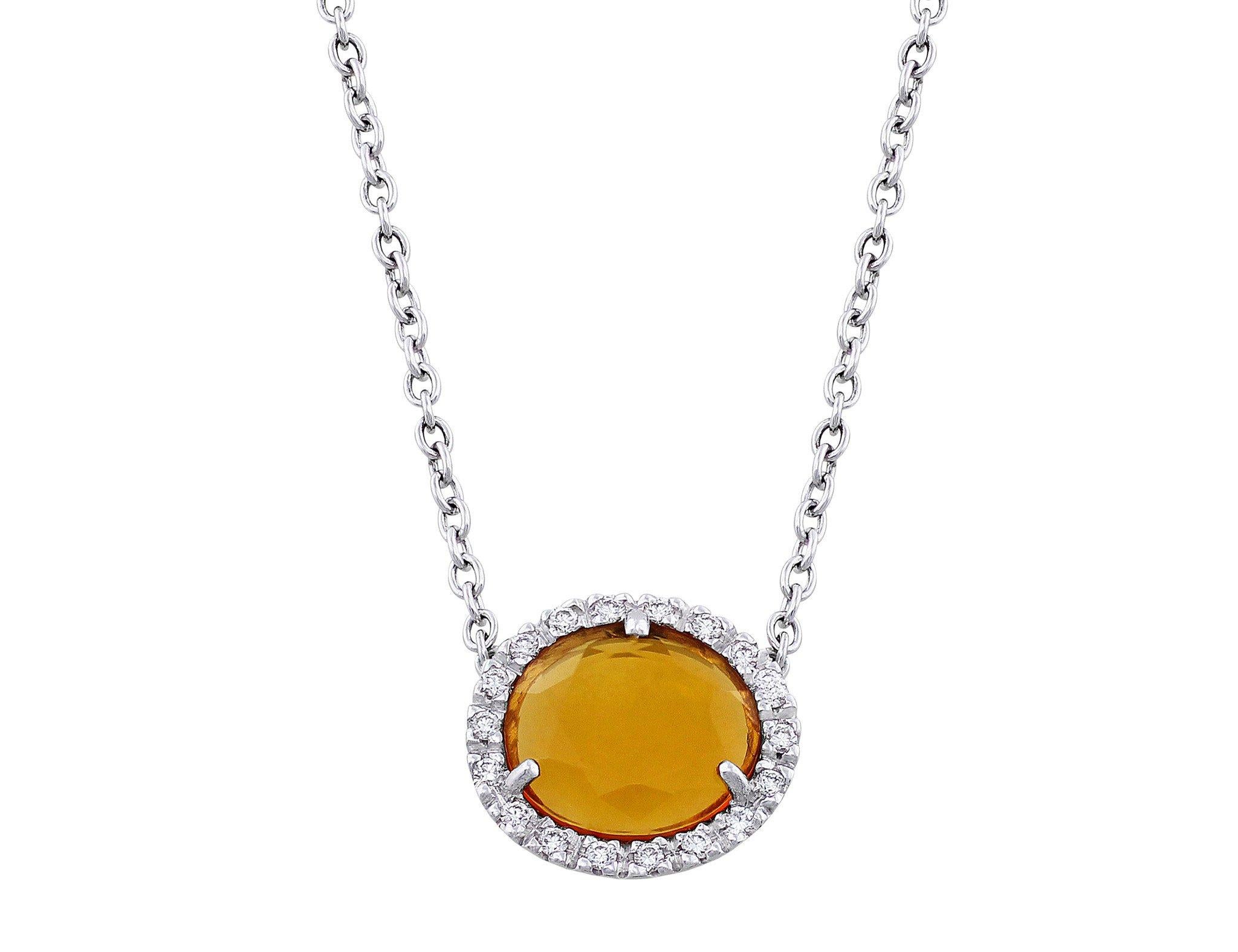 Lovely Pomellato Colpo Di Fulmine necklace comprising a pendant of a round citrine surrounded by diamonds weighing a total of 0.09cttw suspended on an 18k white gold chain.