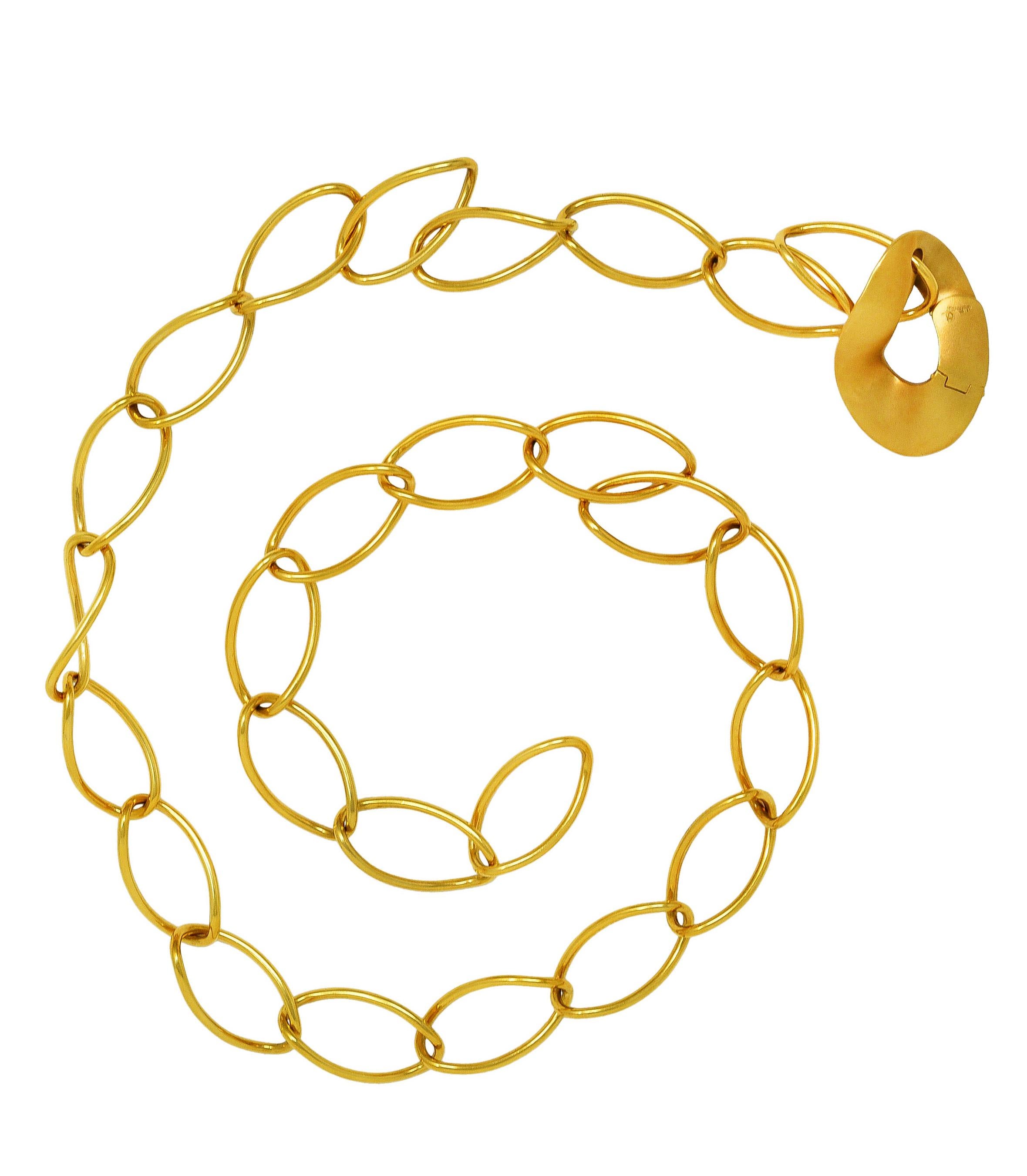 Necklace is designed as large twisted oval links. With single flat matte gold link. Completed by hidden hinged clasp. Stamped 750 for 18 karat gold. Numbered and fully signed for Pomellato. With Italian assay marks for Milan, Italy. Circa: 21st