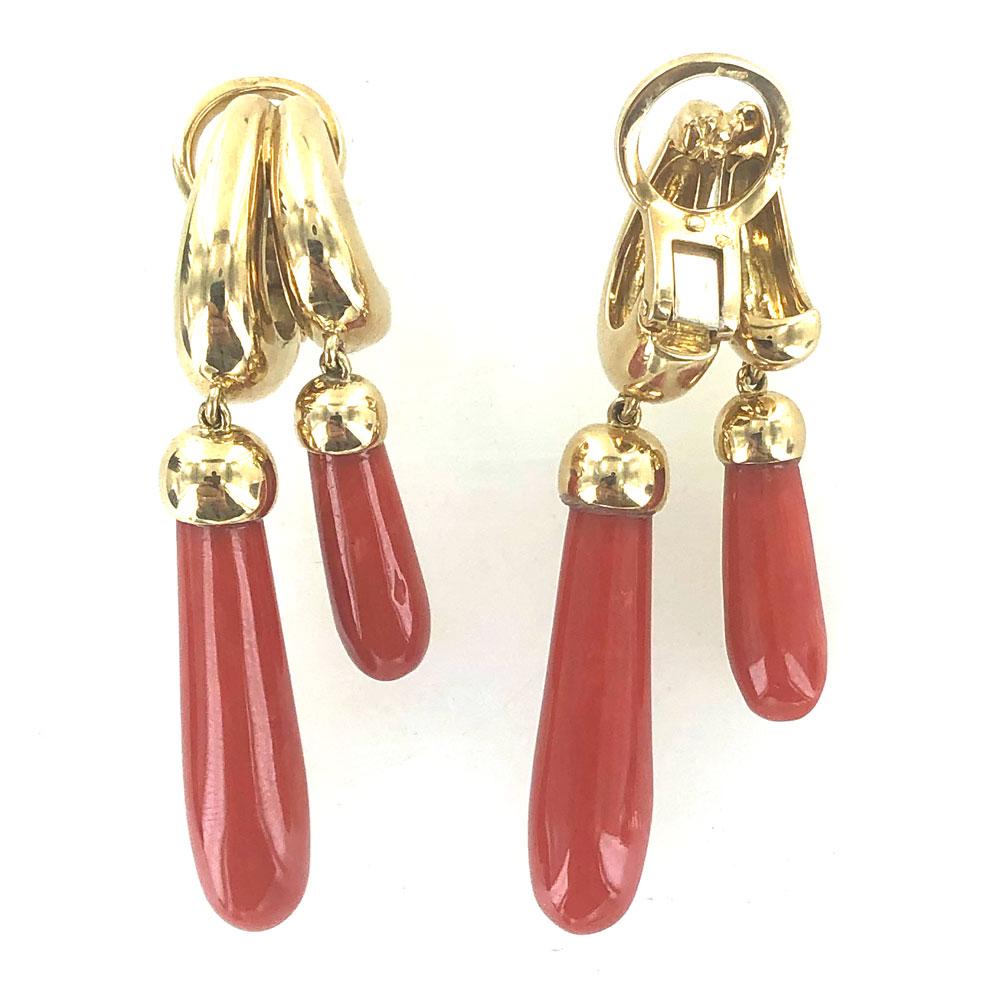 Fabulous coral drop earrings by Italian designer Pomellato. These estate earrings feature double red coral drops fashioned in 18 karat yellow gold. The earrings measure 2.0 inches in length, and are signed Pomellato 18k and hallmarked. 