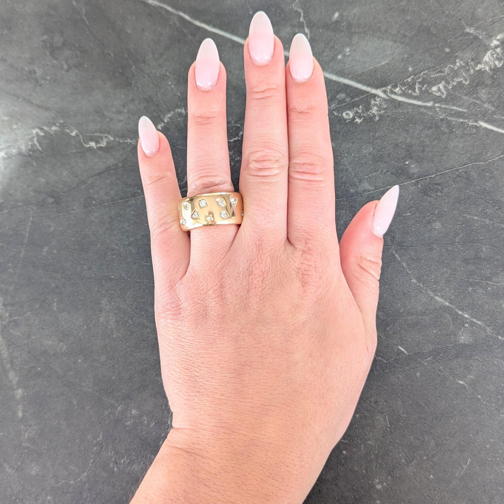 Designed as a puffed wide band ring with grooved shapes fully around
Including stars, squares, triangles marquise, and tear-drop shapes
Each bead set with a round brilliant cut diamond
Weighing approximately 0.80 carat total
G color with VS2