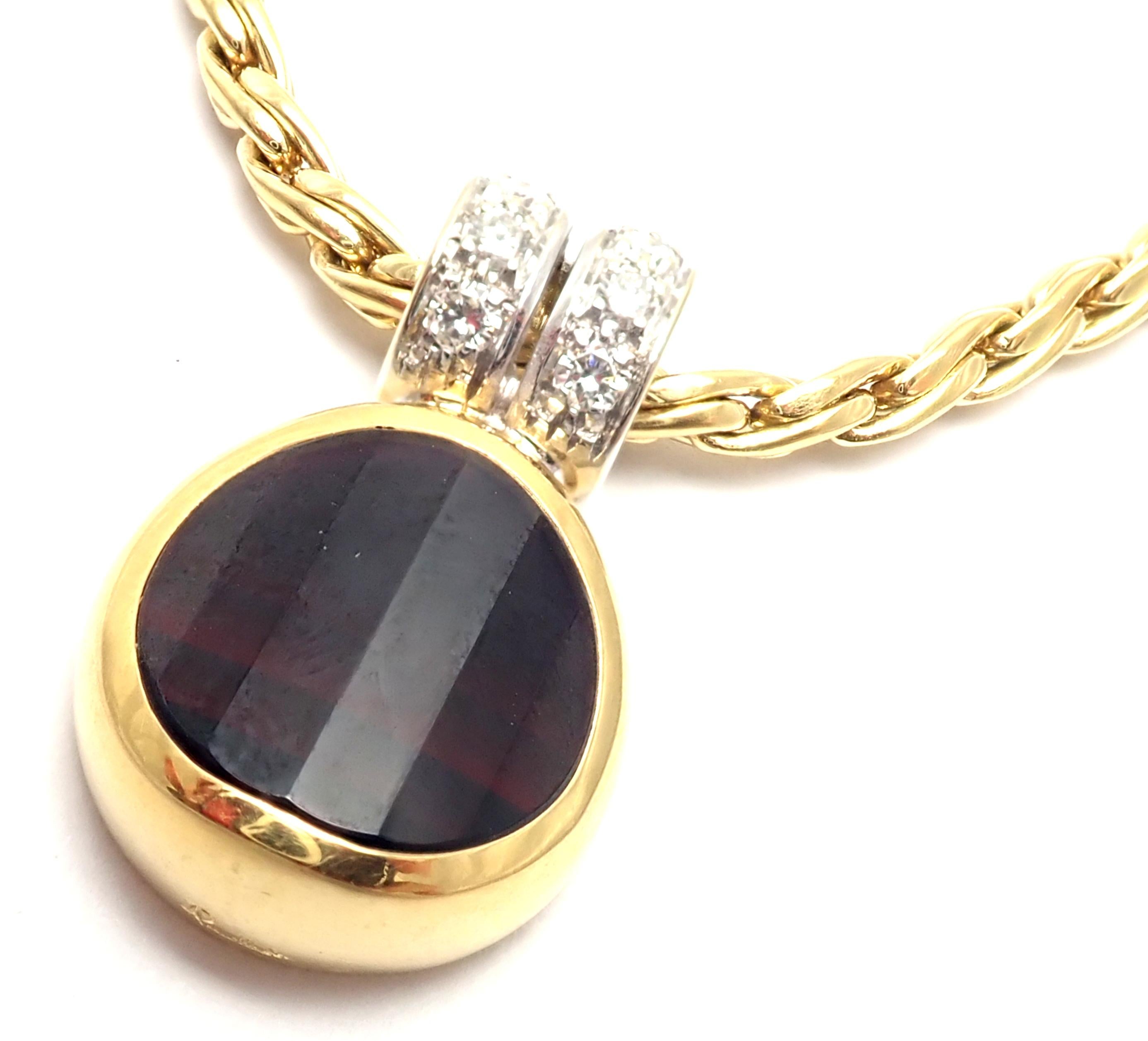 18k Yellow Gold Garnet Pendant Link Necklace by Pomellato. 
With 1 garnet 14mm x 13mm
8 round brilliant cut diamonds VS1 clarity, G color
total weight approx. .25ct
This necklace comes with original box.
Details: 
Weight: 31.3 grams
Chain - Length: