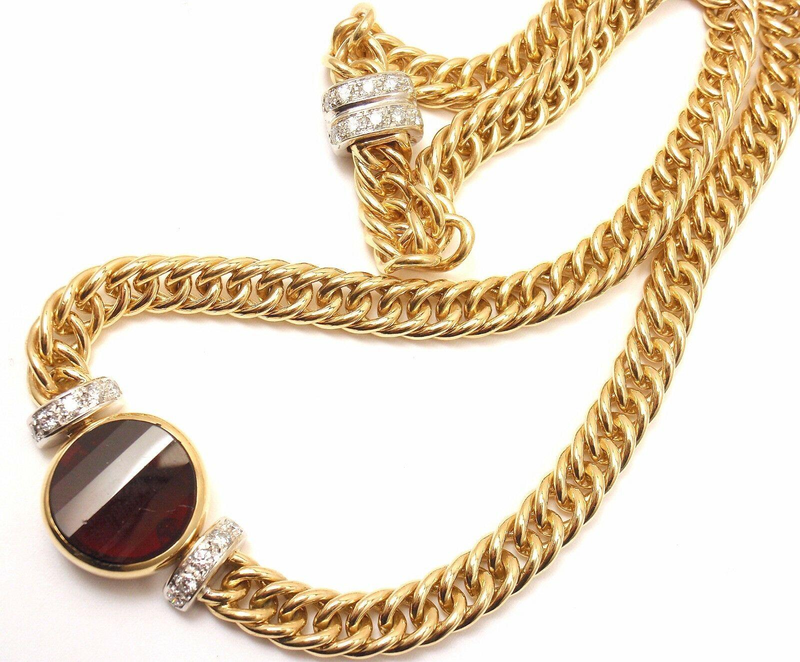 18k Yellow + White Gold Garnet Pendant Link Necklace by Pomellato. 

With 1 garnet 15mm x 15mm
20 round brilliant cut diamonds VS1 clarity, G color
total weight approx. .60-1 ctw

Details: 
Weight: 70.0 grams
Chain - Length: 16