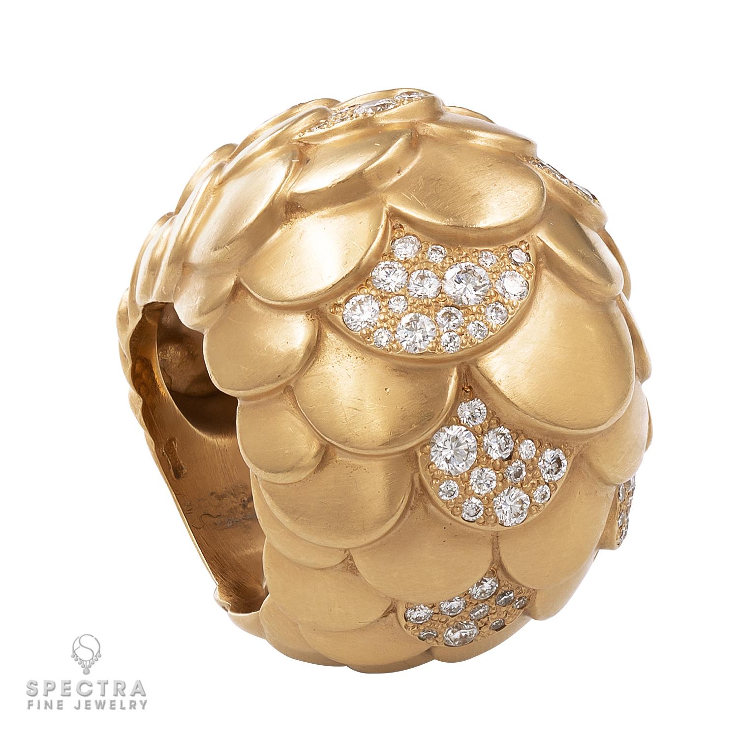 The soft and sensual forms of this playfully oversized bombé or domed style cocktail ring make this signed Pomellato so tactilely pleasing and intriguing. The ring, crafted in 18K rose gold embellished with round diamonds weighing approximately 1.32