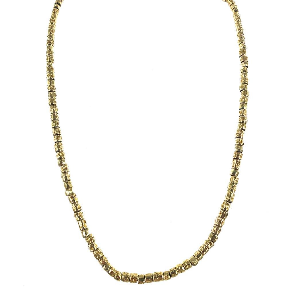 Pomellato 18 karat yellow gold necklace is part of the Dodo collection. The beads are all 18 karat yellow gold and are strung on an unseen underlying sterling silver chain. The necklace measures 17.5 inches in length, has a toggle clasp, and weighs