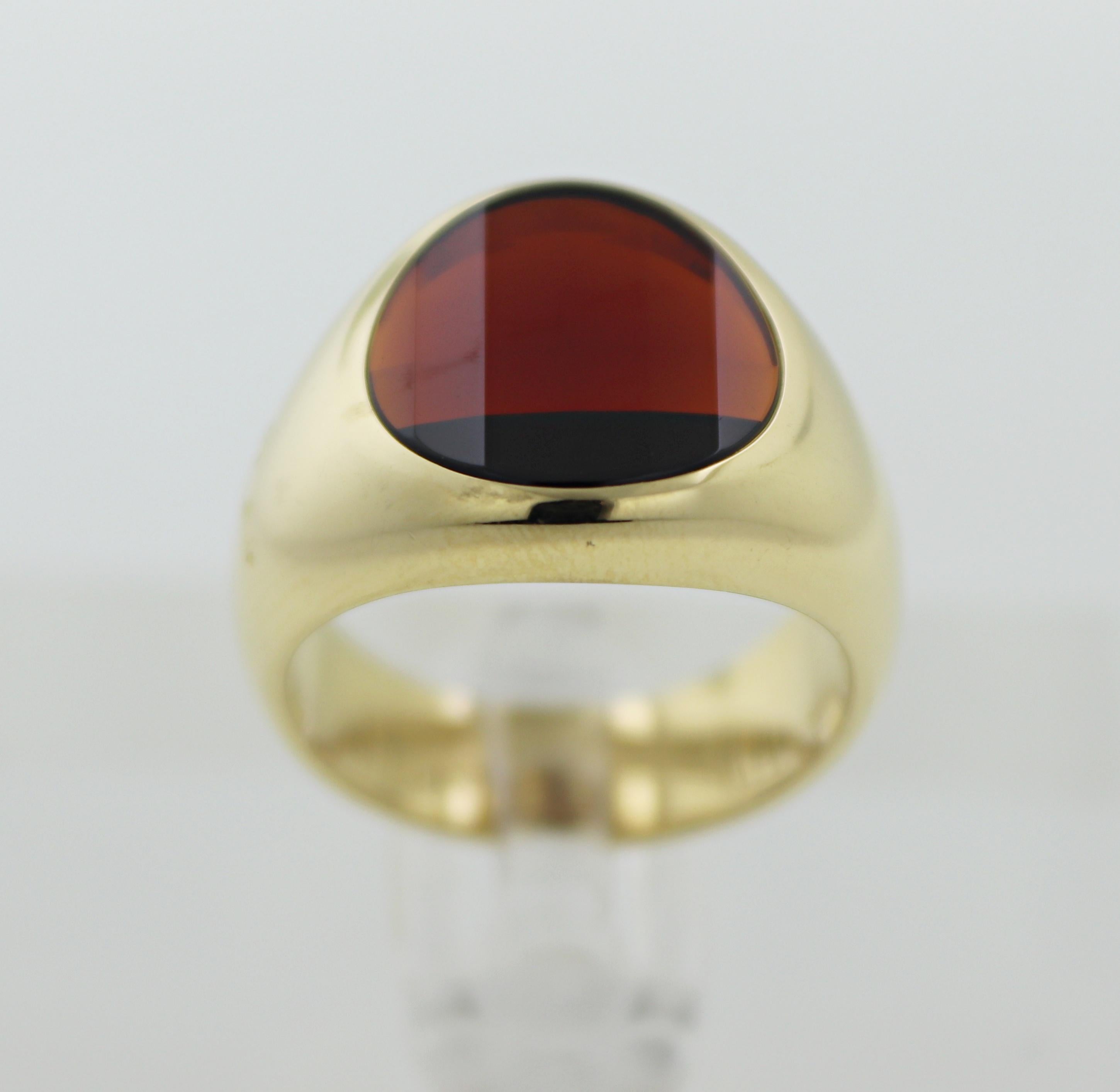 Featuring (1) faceted top round-cut garnet, 12.00 X 12.00 X 2.00 mm, flush set in a 14k yellow gold gypsy
mounting, tapering from 13.9 to 5.7 mm, size 5.75, marked Pomellato, 750, 18K, Italian hallmarks, 11.45 grams.