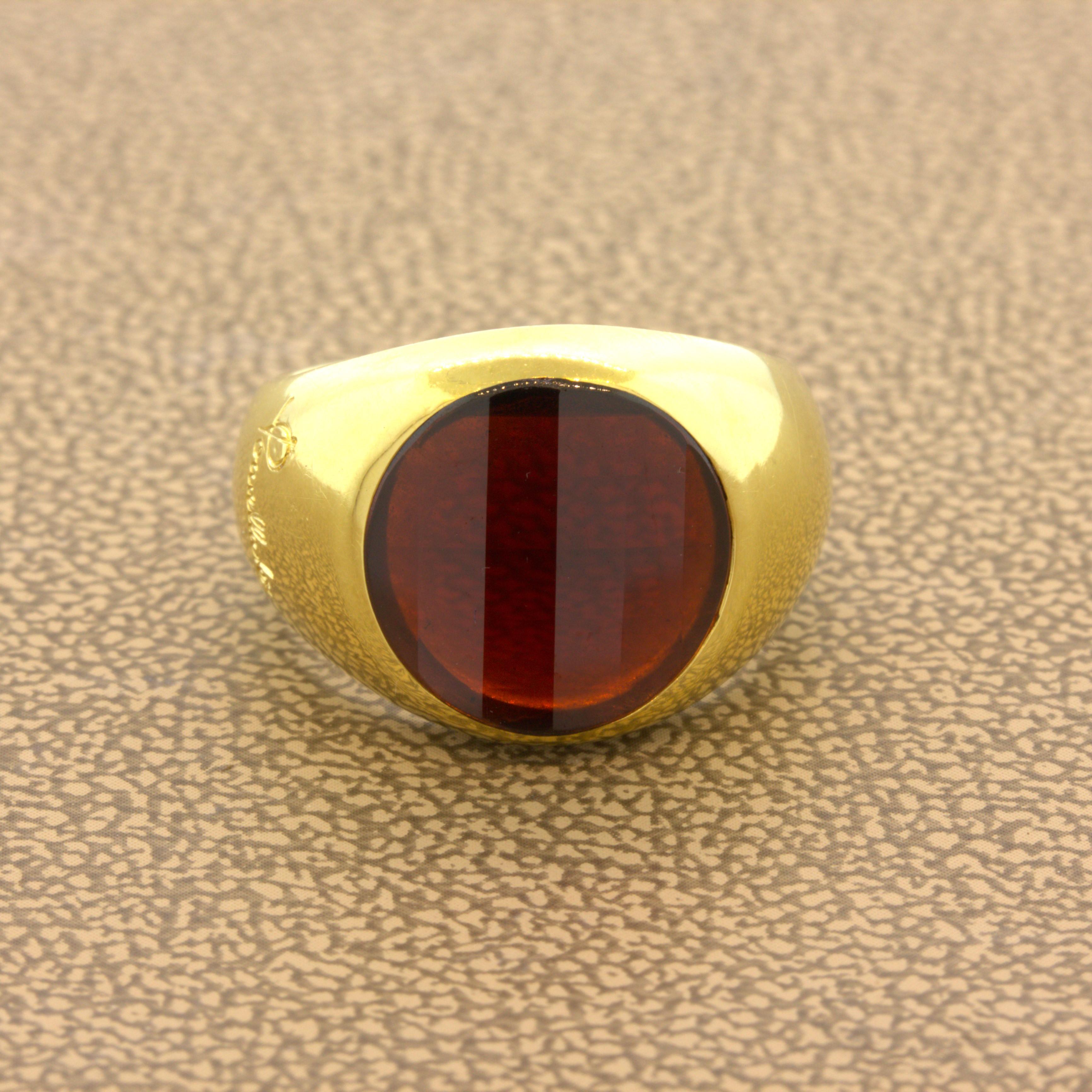 A simple yet very stylish ring by Italian designer Pomellato. The ring features a rich orangy-red garnet with a very unique cutting style we have never seen before. On the stones table are vertical step-cuts while the pavilion (bottom) has