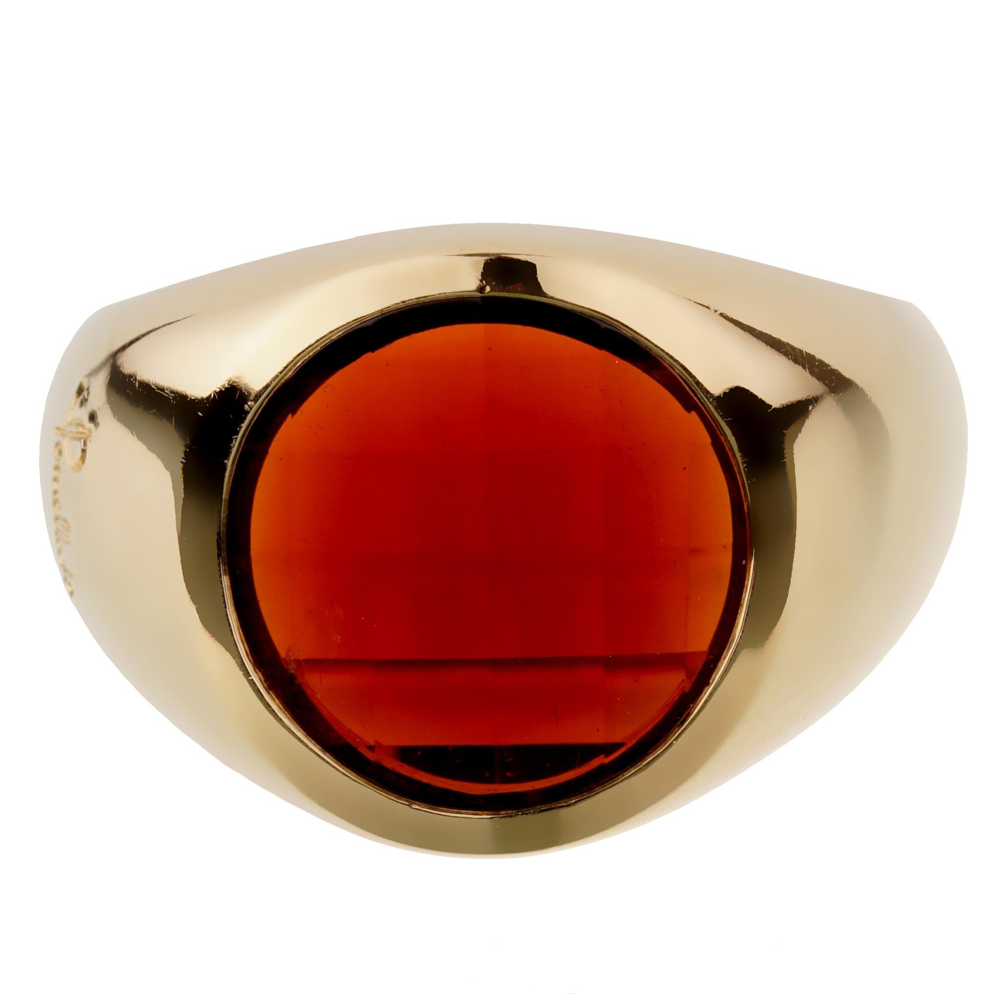 A chic Pomellato cocktail ring showcasing a round step cut garnet in 18k yellow gold. The ring measures a size 6 3/4 and can be resized if needed.