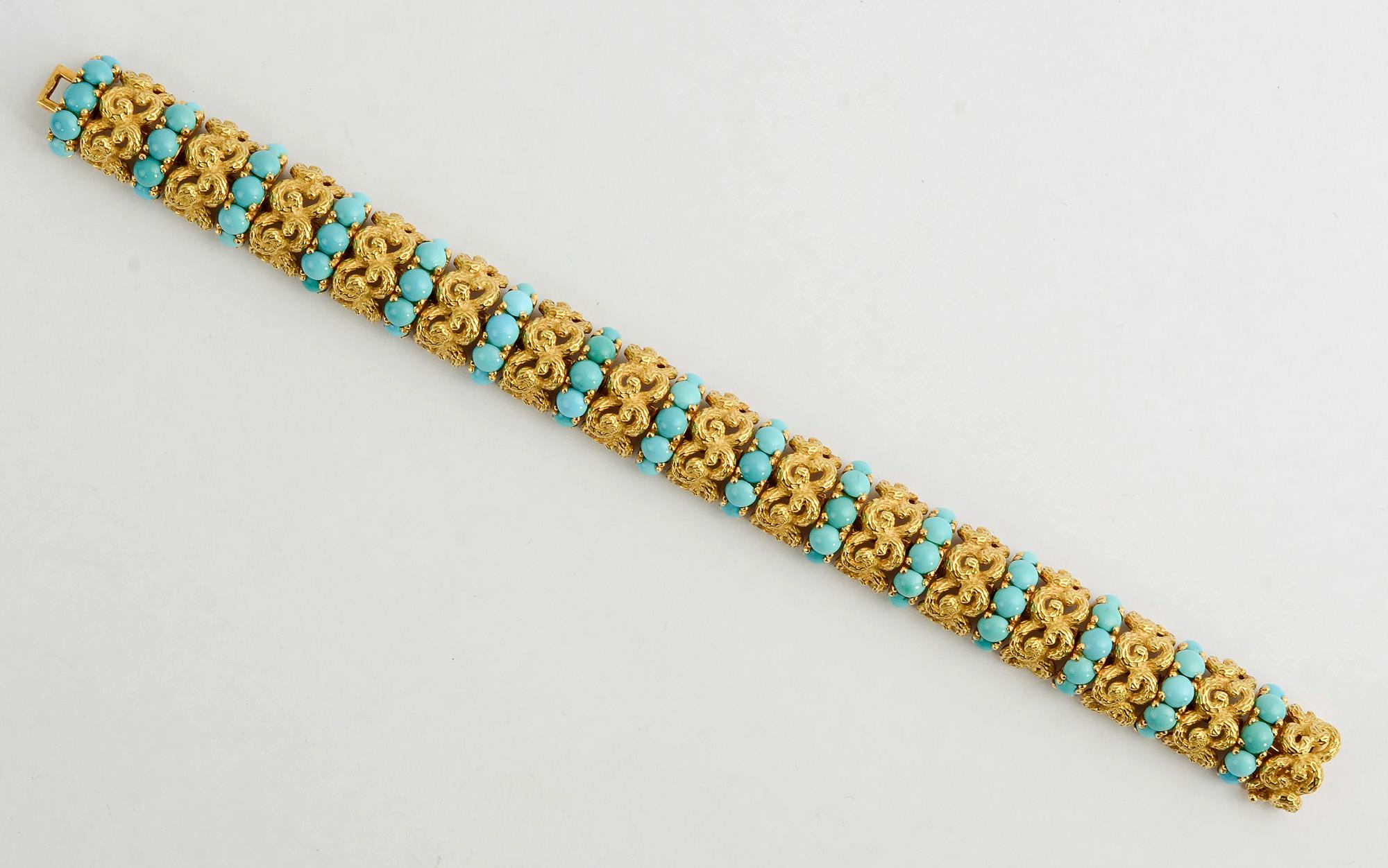 Finely made bracelet by Pomellato of intricately intertwined textured links. Each group of gold links is separated by a row of five beautifully colored natural turquoise stones. The bracelet has a graceful arch. It is 7 3/8 inches in length with a