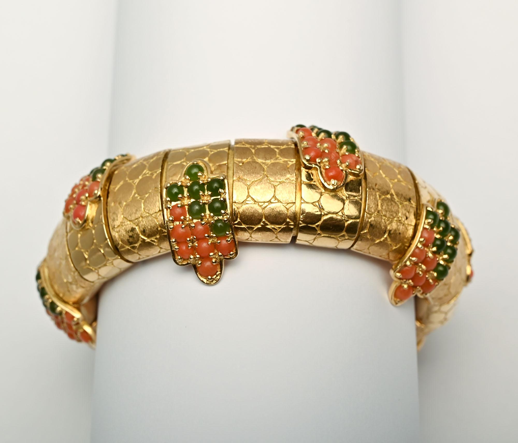 Absolutely stunning and unusual heavy gold bracelet by Pomellato. The bracelet has 19 arched links . Every other one is embellished with emeralds and coral. All of the links have an incised pattern of circles abutting one another. The clasp is