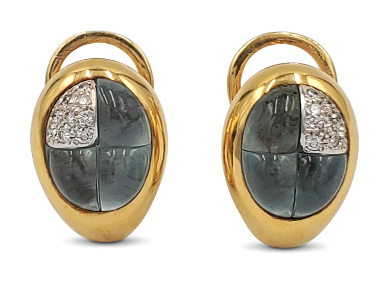 Authentic Pomellato earrings crafted in 18 karat yellow gold centering on three sections of carved cabochon blue topaz stones and one section of an estimated 0.18 round brilliant cut diamonds (F-G color, VS clarity). 