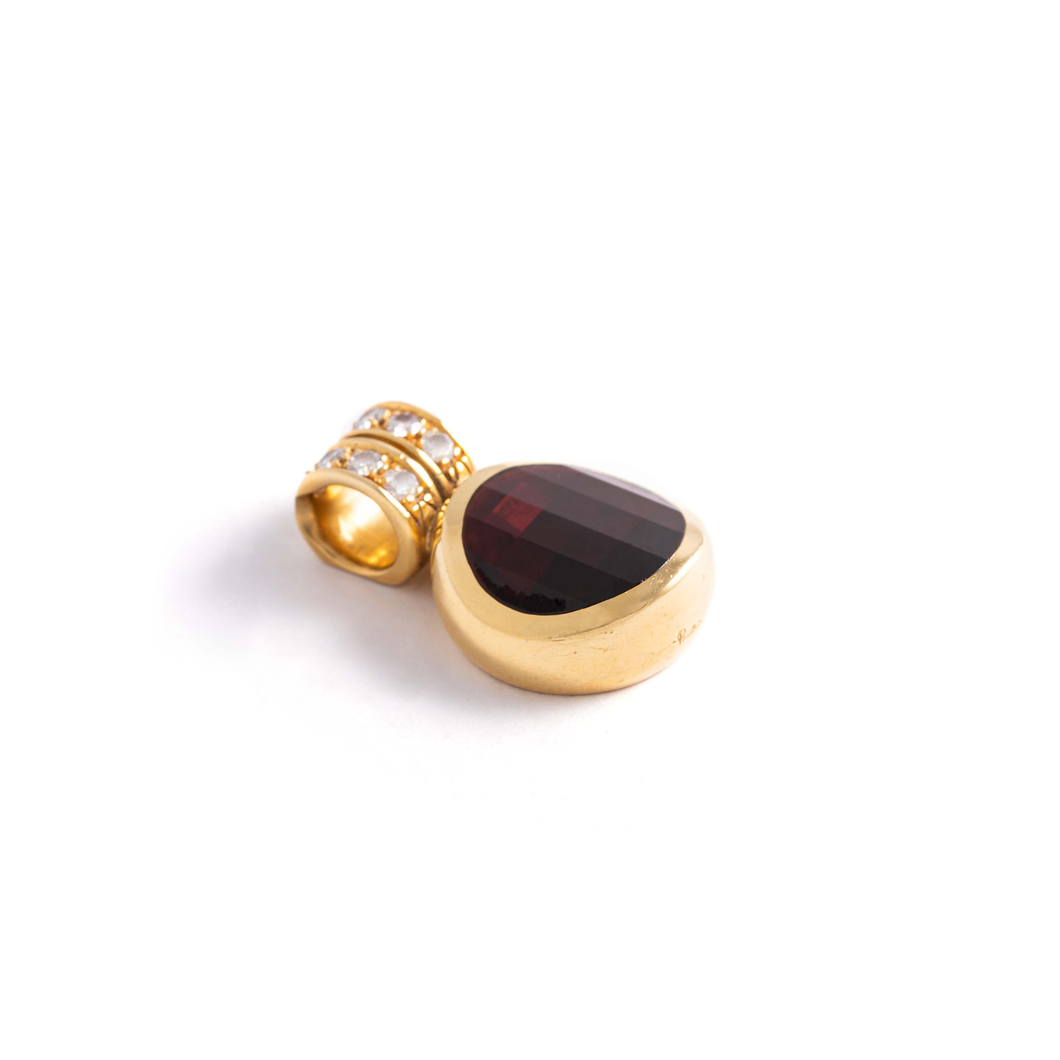 Women's or Men's Pomellato. Gold pendant holding a faceted garnet set with round-cut diamonds.