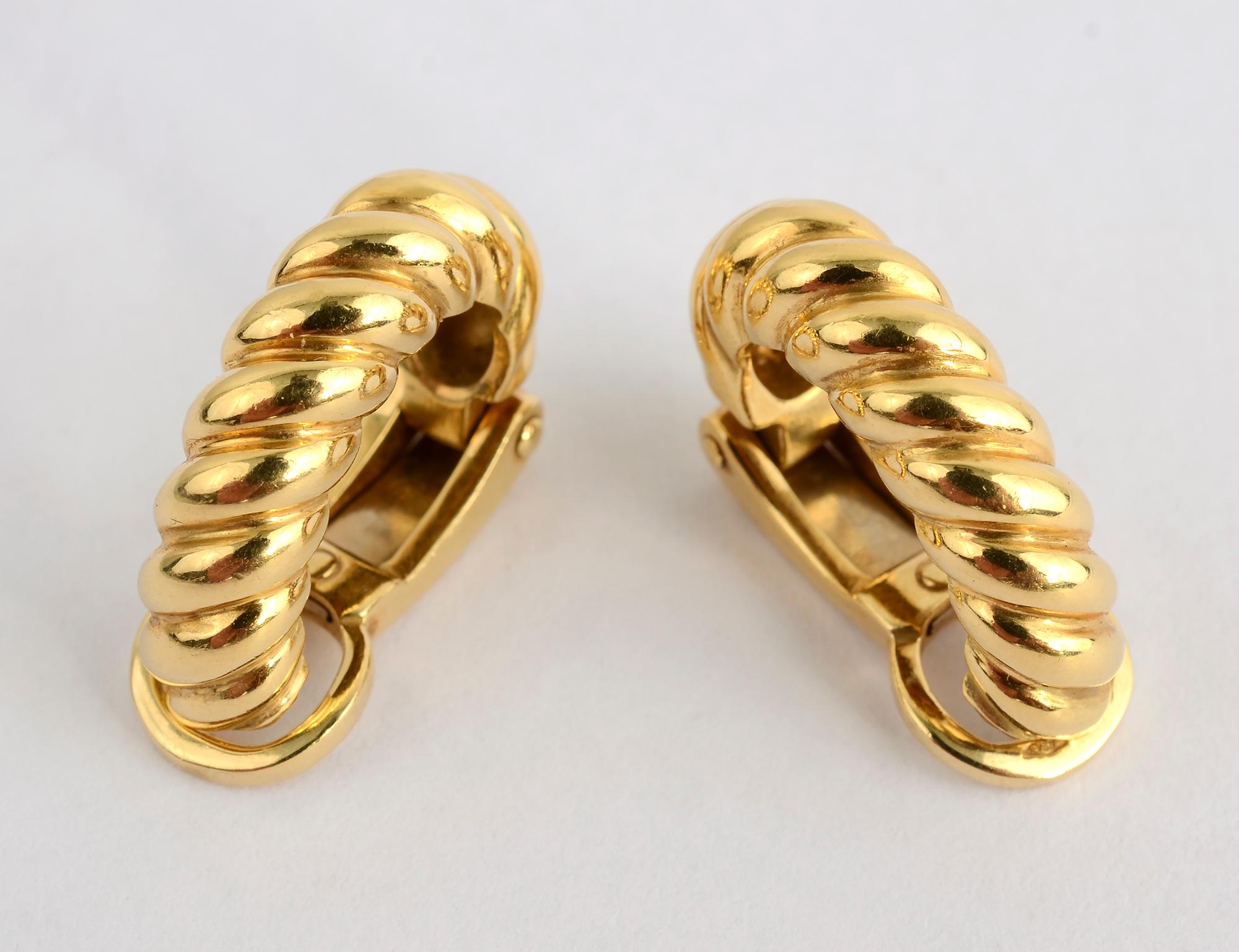 Lovely elongated half hoop earrings by Pomellato that are the perfect pair to wear all day, every day. They are of a twisted gold rope design in 18 karat gold. They are 3/4 