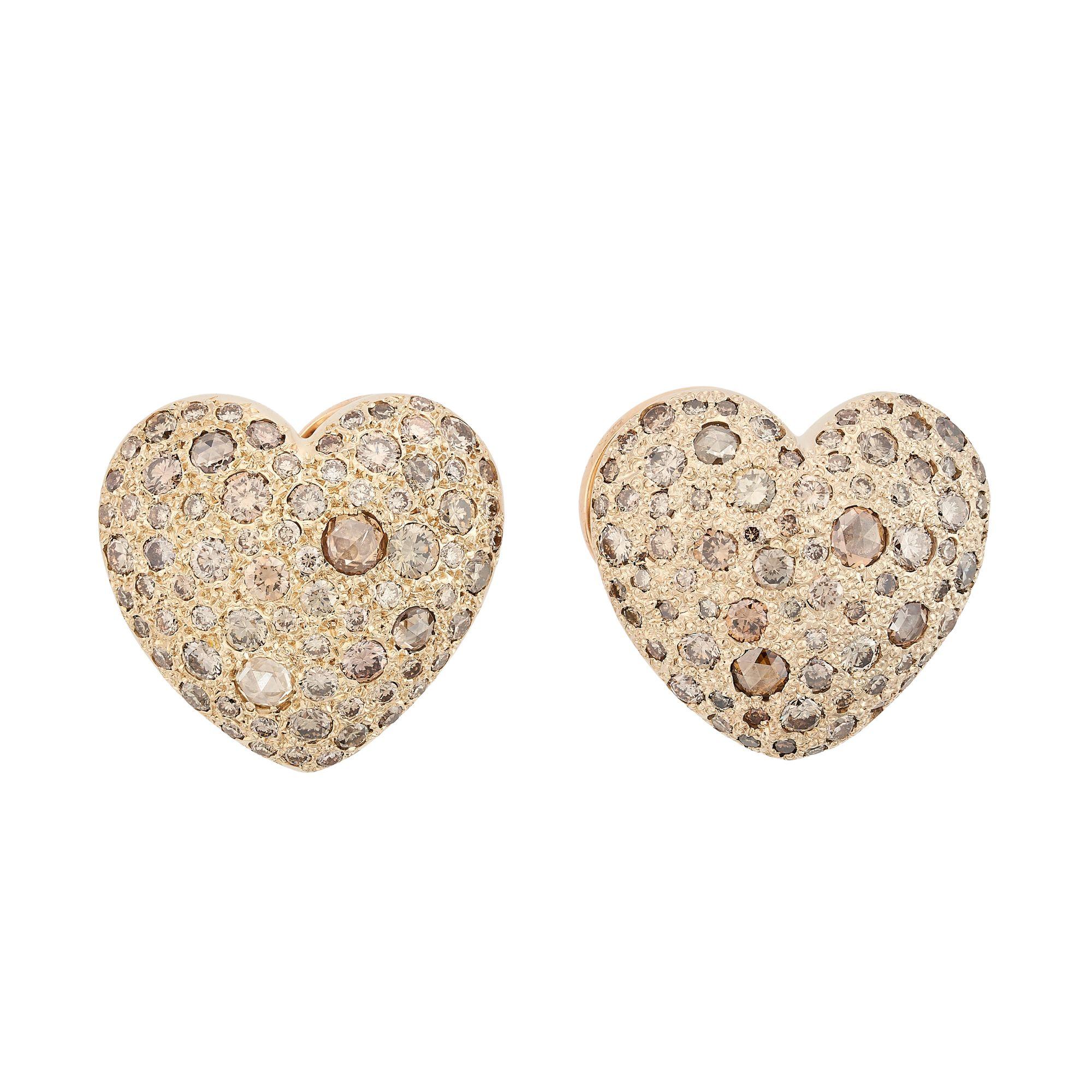 Famed Italian jeweler, Pomellato stuns again with these slightly bombe heart-shaped ear clips encrusted with colored diamonds. I8k yellow gold combines with approximately 4.25 carats of diamonds to create a shimmering feeling of love.