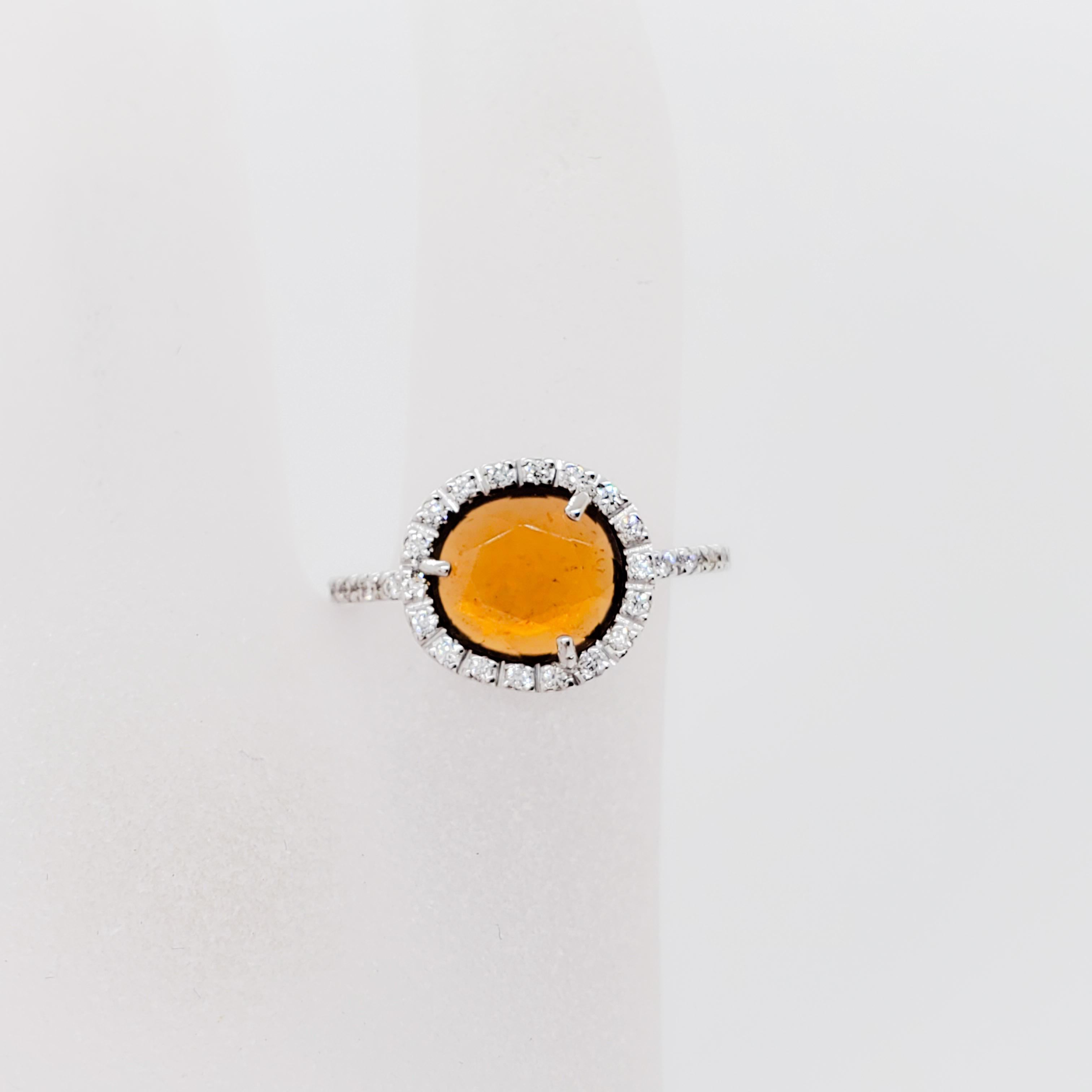 Gorgeous Pomellato cocktail ring featuring 0.75 ct. hessonite garnet and 0.15 ct. white diamond round ring in a handmade 18k white gold mounting.  Ring size 5.25.  Dainty and luxurious.
