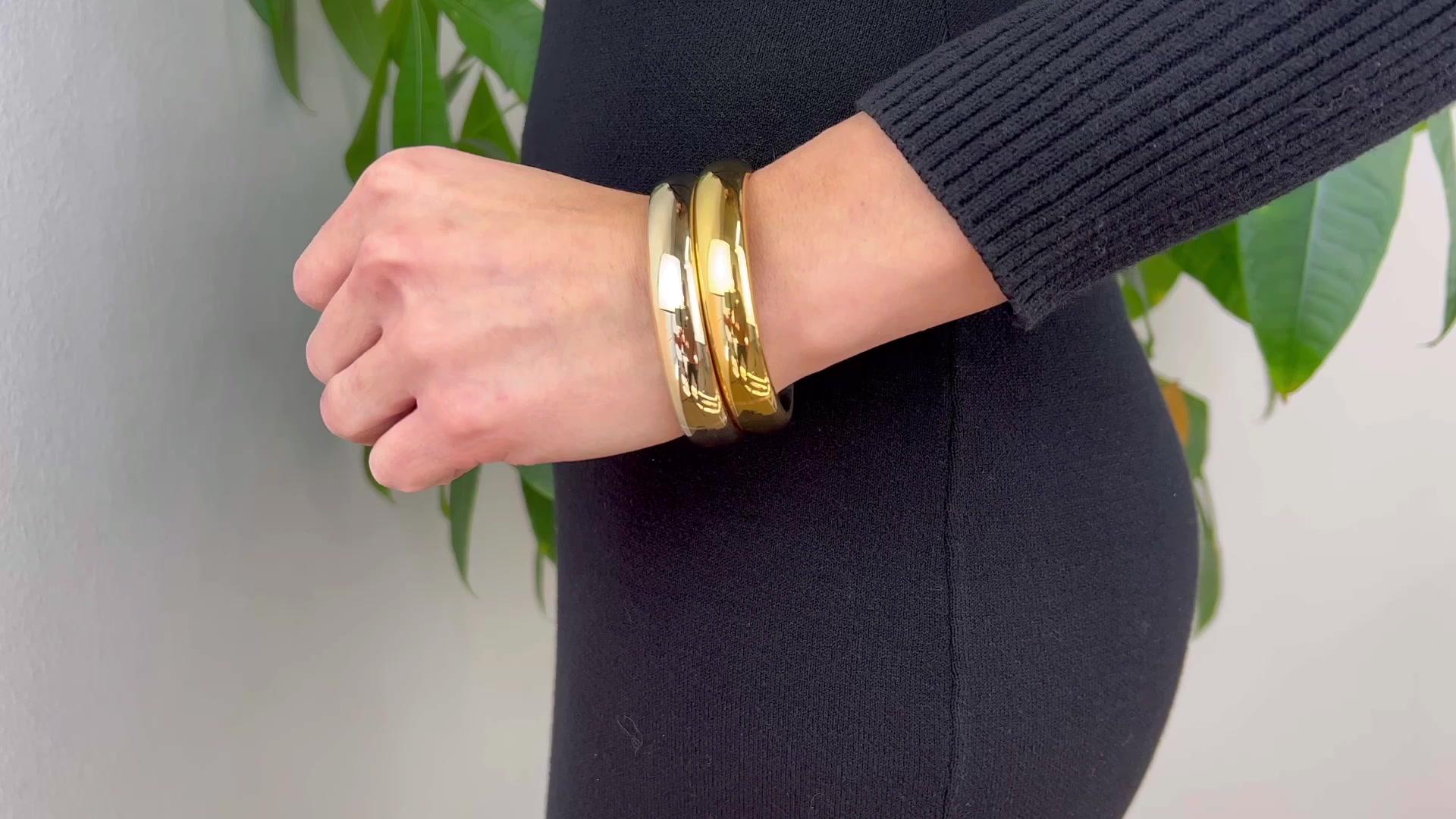 One Pomellato Italian 18 Karat Gold Iconica Bangle Bracelet Set. Crafted in 18 karat yellow and rose gold signed Pomellato with Italian hallmarks. Circa 2000. The bracelets are 6 3/4 inches in circumference.

About this Item: Imagine embodying the