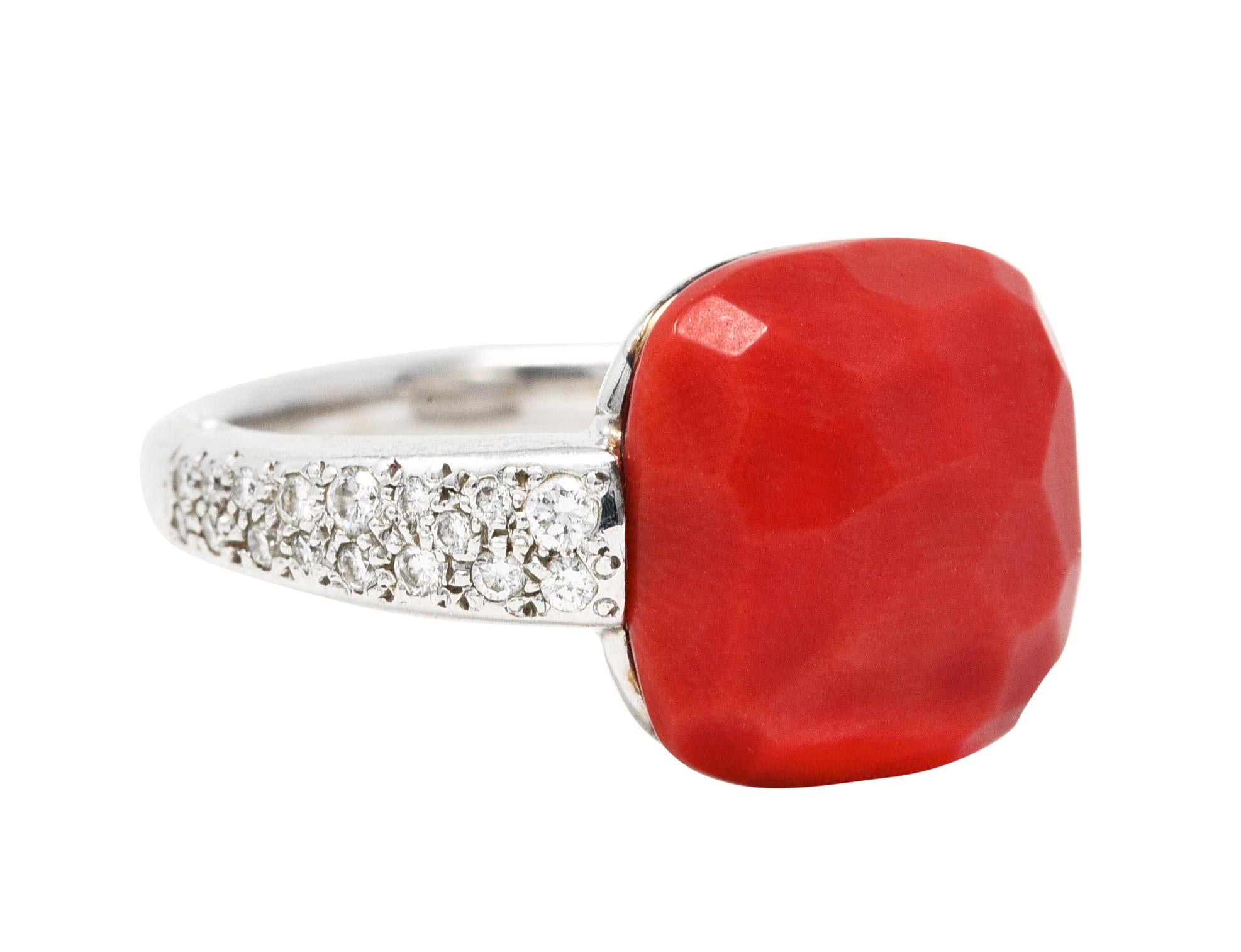 Featuring a cushion cut cabochon of coral measuring approximately 12.7 x 12.7 mm

Opaque pastel orangey red in color with a faceted finish and very good polish

Flanked by pavè diamond shoulders

Round brilliant cut diamonds weigh in total