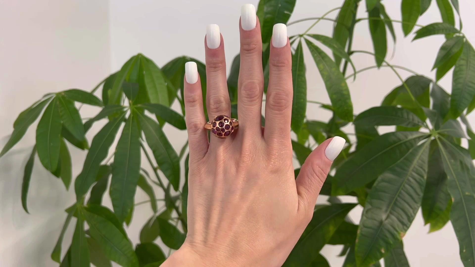 One Pomellato Italian Rhodolite Garnet 18 Karat Rose Gold Harem Cocktail Ring. Featuring 28 rose cut rhodolite garnets with a total weight of approximately 12.40 carats. Crafted in 18 karat rose gold signed Pomellato with Italian hallmarks. Circa