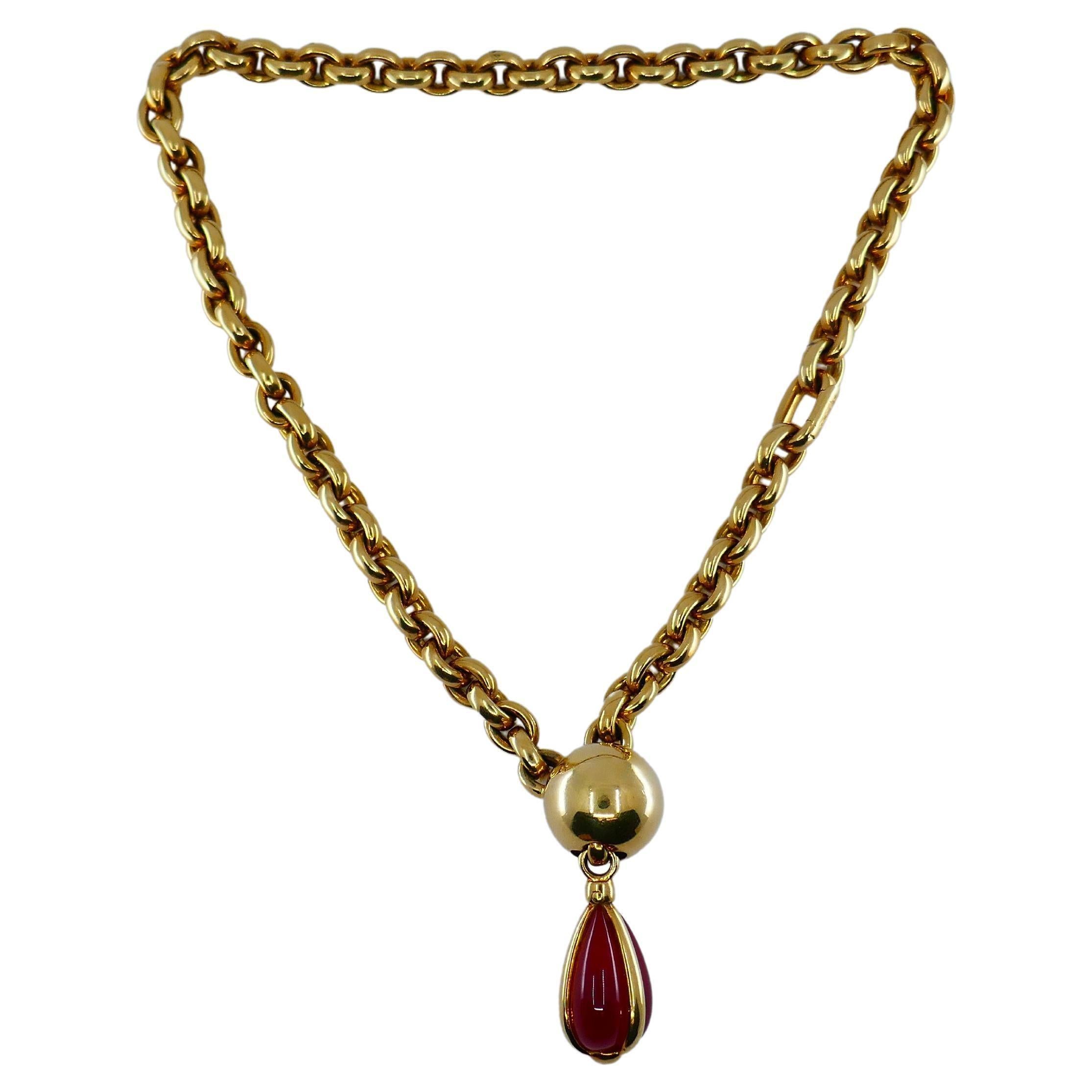 A spectacular Pomellato 18k gold lariat chain necklace with a carnelian pendant.
The lariat part is designed as a polished gold ball. It rhymes with the massive tear-shape carnelian pendant. The stone is staged in three gold bands that 