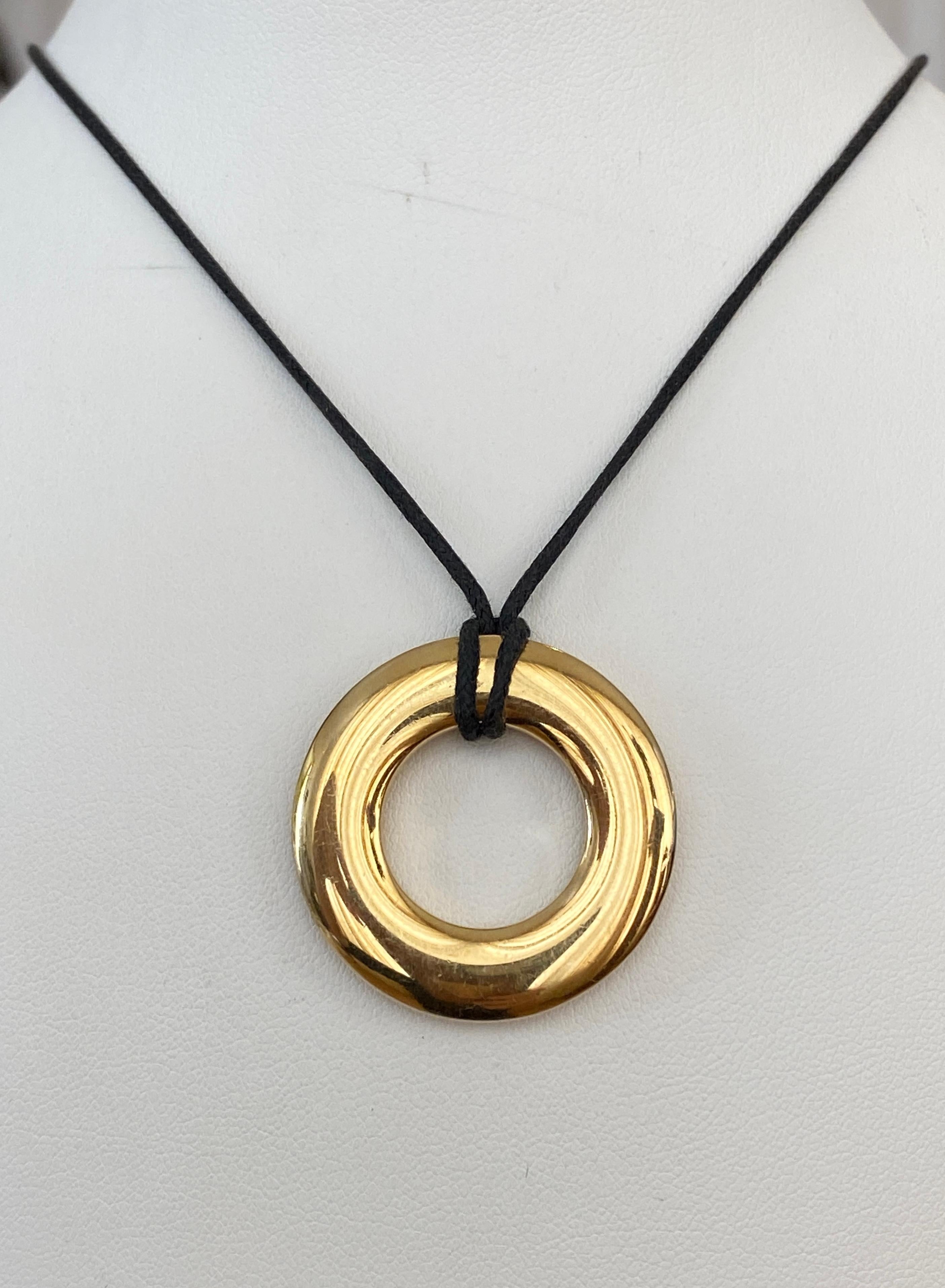 Offered in good condition  Pomellato necklace designed as a circular yellow  gold pendant affixed to a leather cord. Signed Pomellato 750 489 MI.
Weight is  21,8 gram 
Cord adjustable up to 58 cm
Size pendant 3cm*3cm
Working for couple of years for