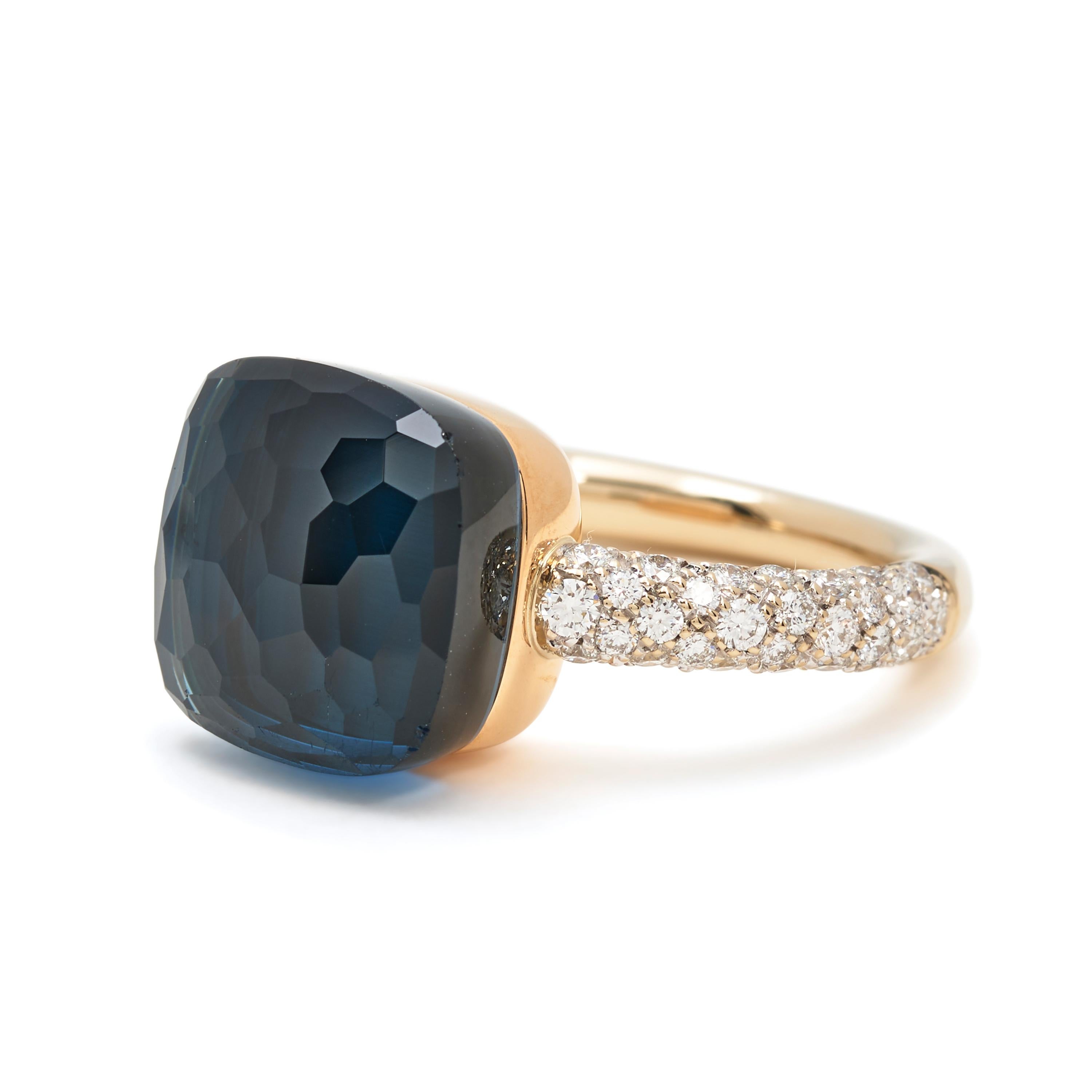 Authentic Pomellato Nudo ring crafted in 18 karat rose and white gold.  The ring features a faceted London blue topaz and diamond set band with approximately .70 carats total diamond weight.  Size 6 1/2.  Signed Pomellato, 750, with hallmark.  Ring