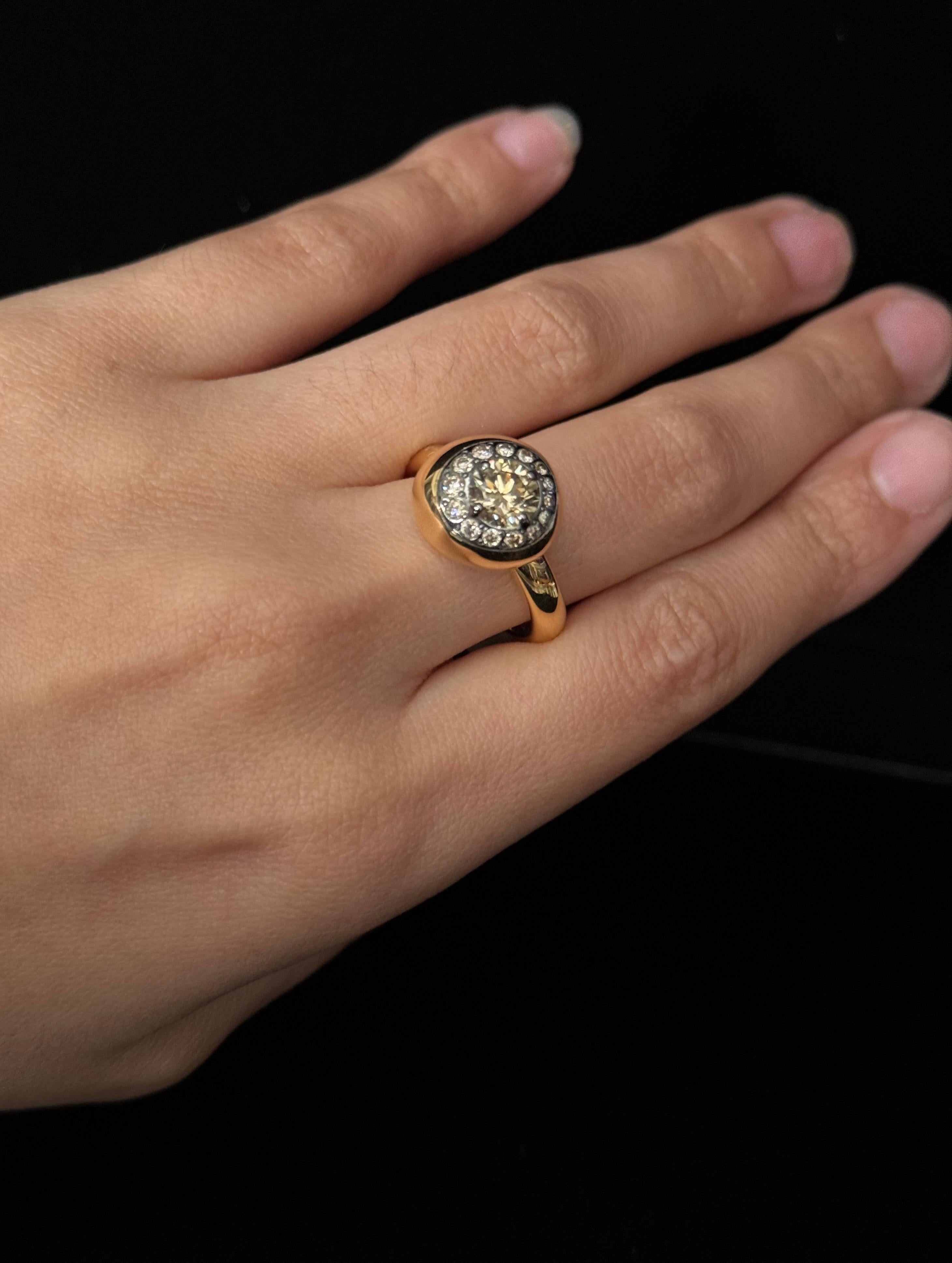 This radiant ring features a brown centered diamond surrounded by a dazzling brown diamond pave. These diamonds are discreetly set into a circular Nuvola style setting on a ring that boasts undoubted luxury and warmth. Created in brightly polished