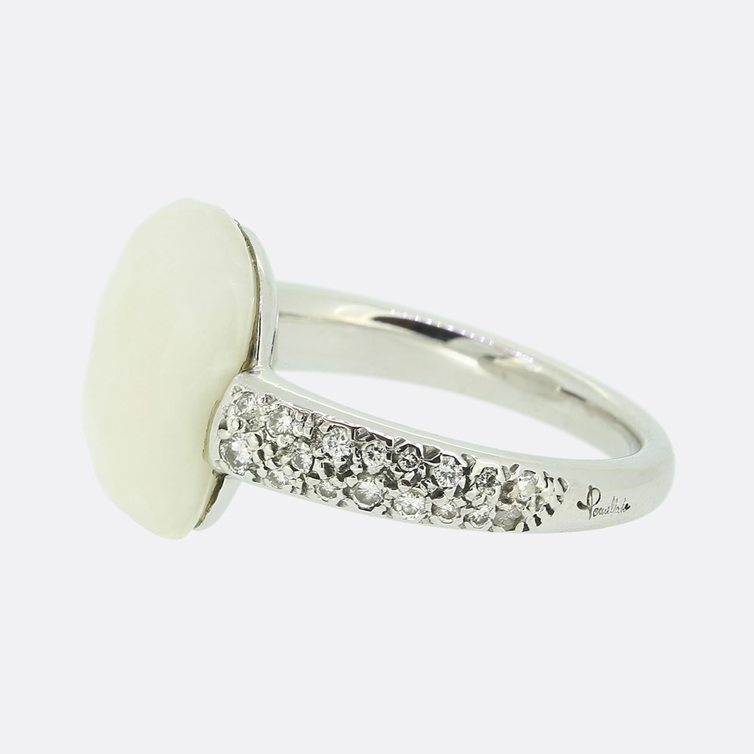 Here we have an 18ct white gold ring from the luxury Italian jewellery designer, Pomellato. The ring features a single faceted white opal which sits alone and proud at the centre of the face. This principal stone is then flanked on either shoulder