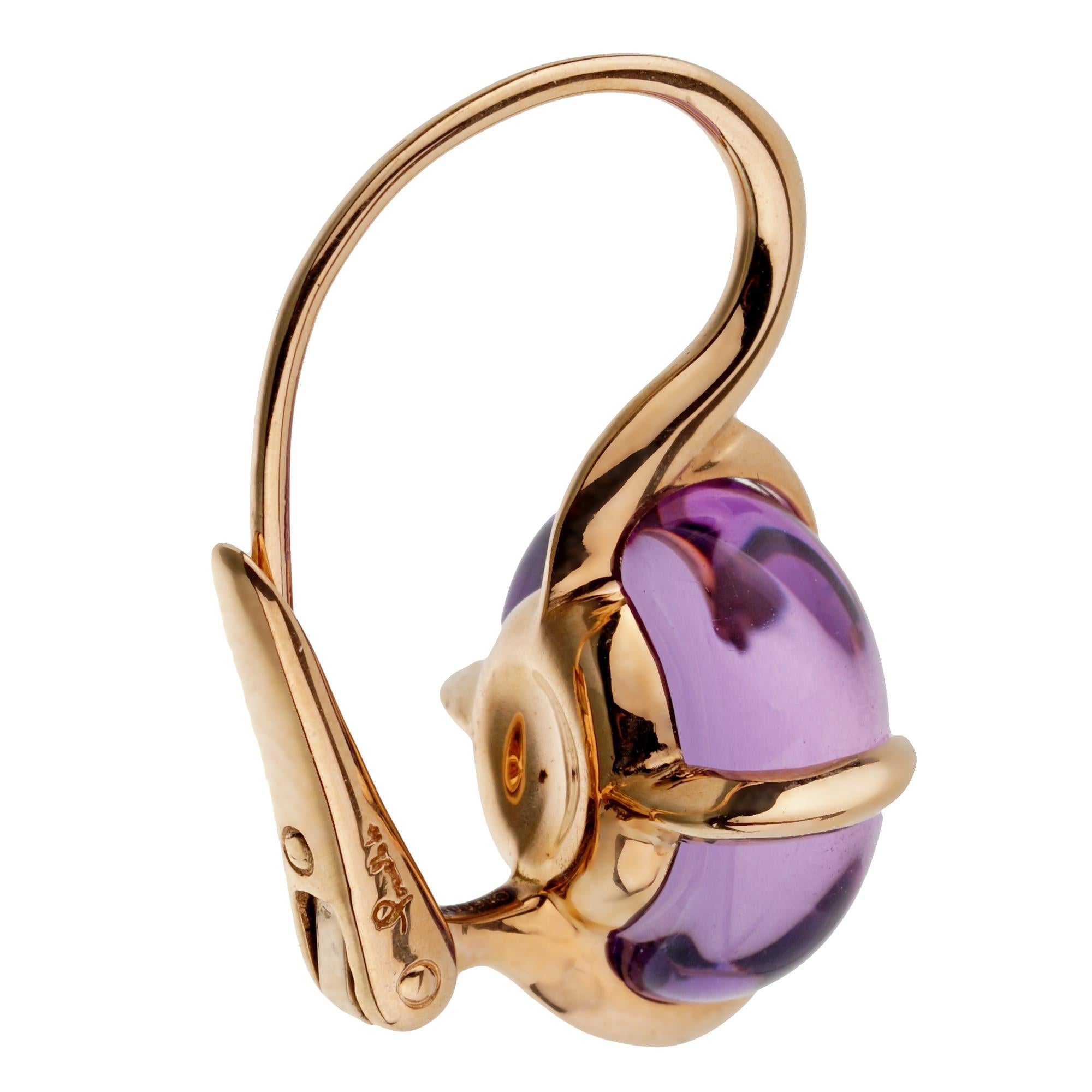 A fabulous pair of authentic Pomellato earrings showcasing 2 cabochon amethyst's weighing 16.60ct total weight in shimmering 18k rose gold. The earrings have a length of 1