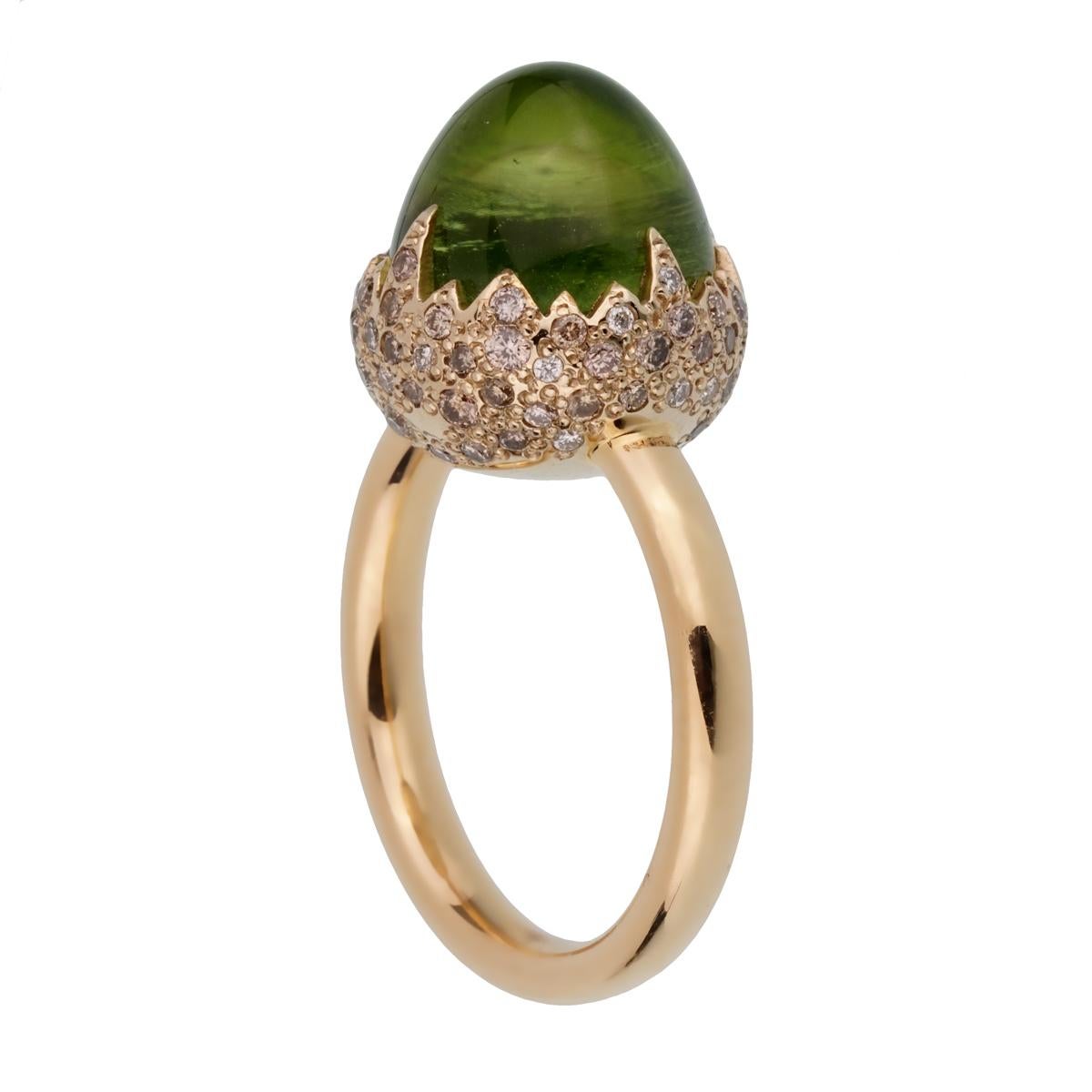 An iconic brand new Pomellato diamond cocktail ring showcasing a 8.30ct total weight Peridot encased with .25ct of round brilliant cut diamonds in shimmering 18k rose gold. The ring measures a size 6 1/2 and can be resized

Pomellato Retail Price: