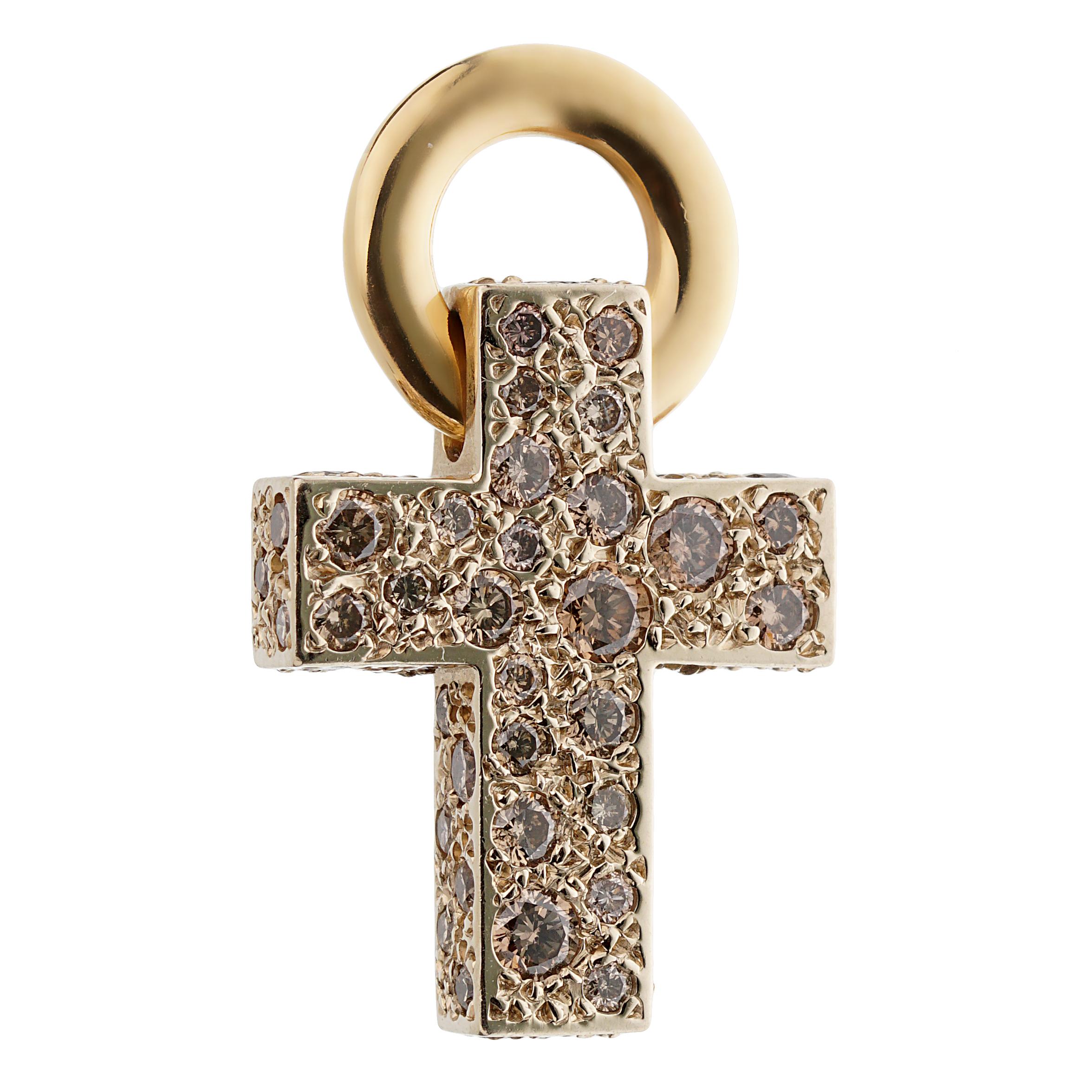 A fabulous Pomellato 18k yellow gold cross pendant set with approximately 1 carat of fancy color diamonds. The pendant measures 1.02