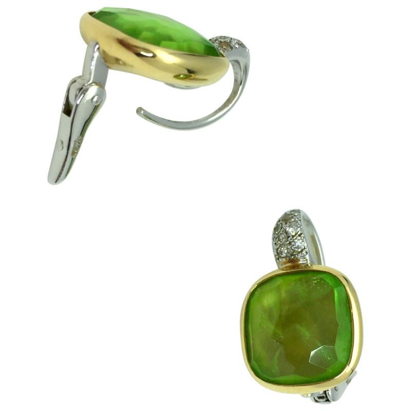 Pomellato 'Sherazade' earrings crafted in 18 karat gold featuring bezel set peridot stones and high-quality round brilliant diamonds weighing an estimated 0.23 carats.
Signed Pomellato,  with serial number.

Original Price: 11,500€

Pomellatto