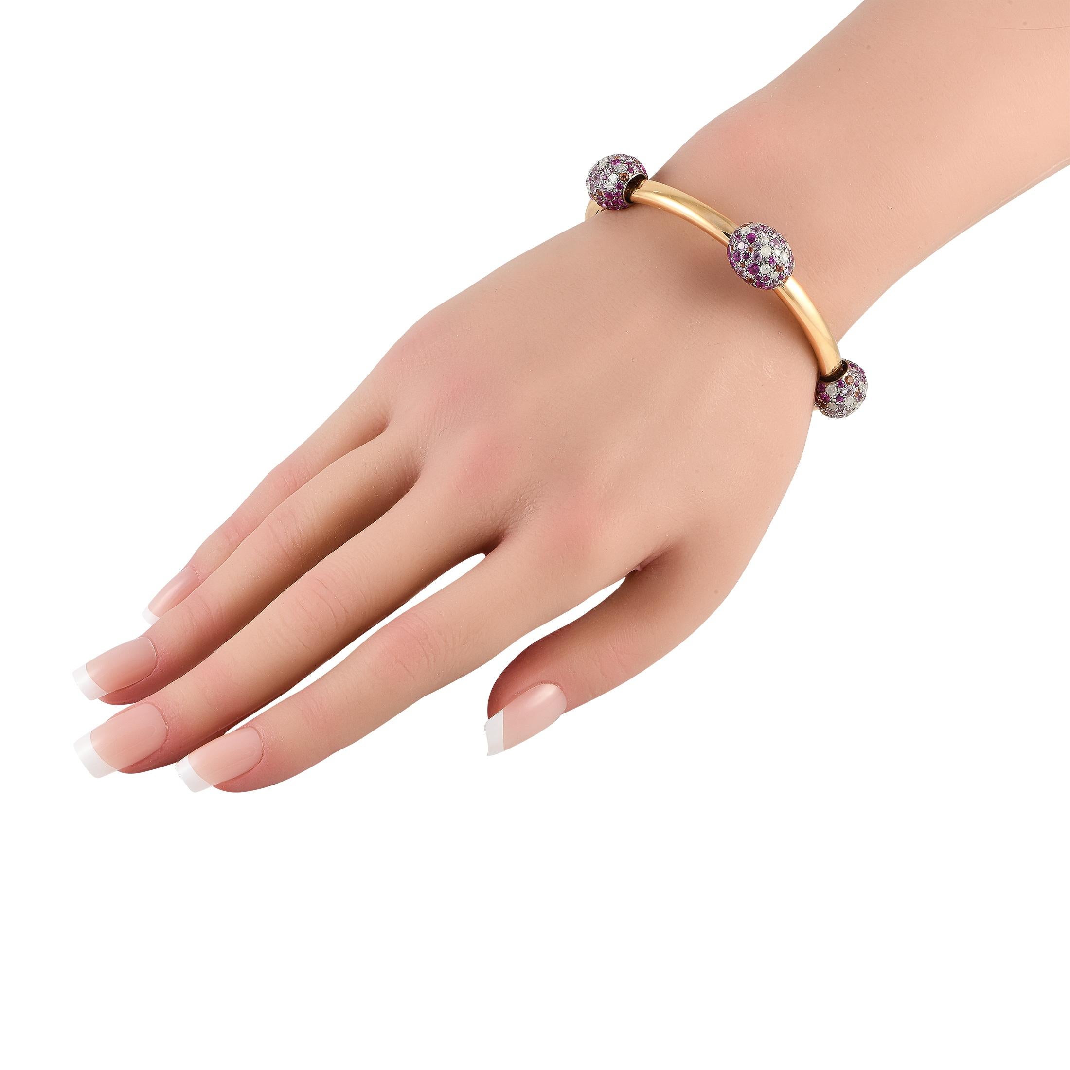 Theres something delightfully unexpected about this Pomellato Tango bracelet. Silver orbs sparkle and shine thanks to a striking combination of Diamonds and Pink Sapphires. The sleek 18K Rose Gold setting adds opulence to the overall design. This