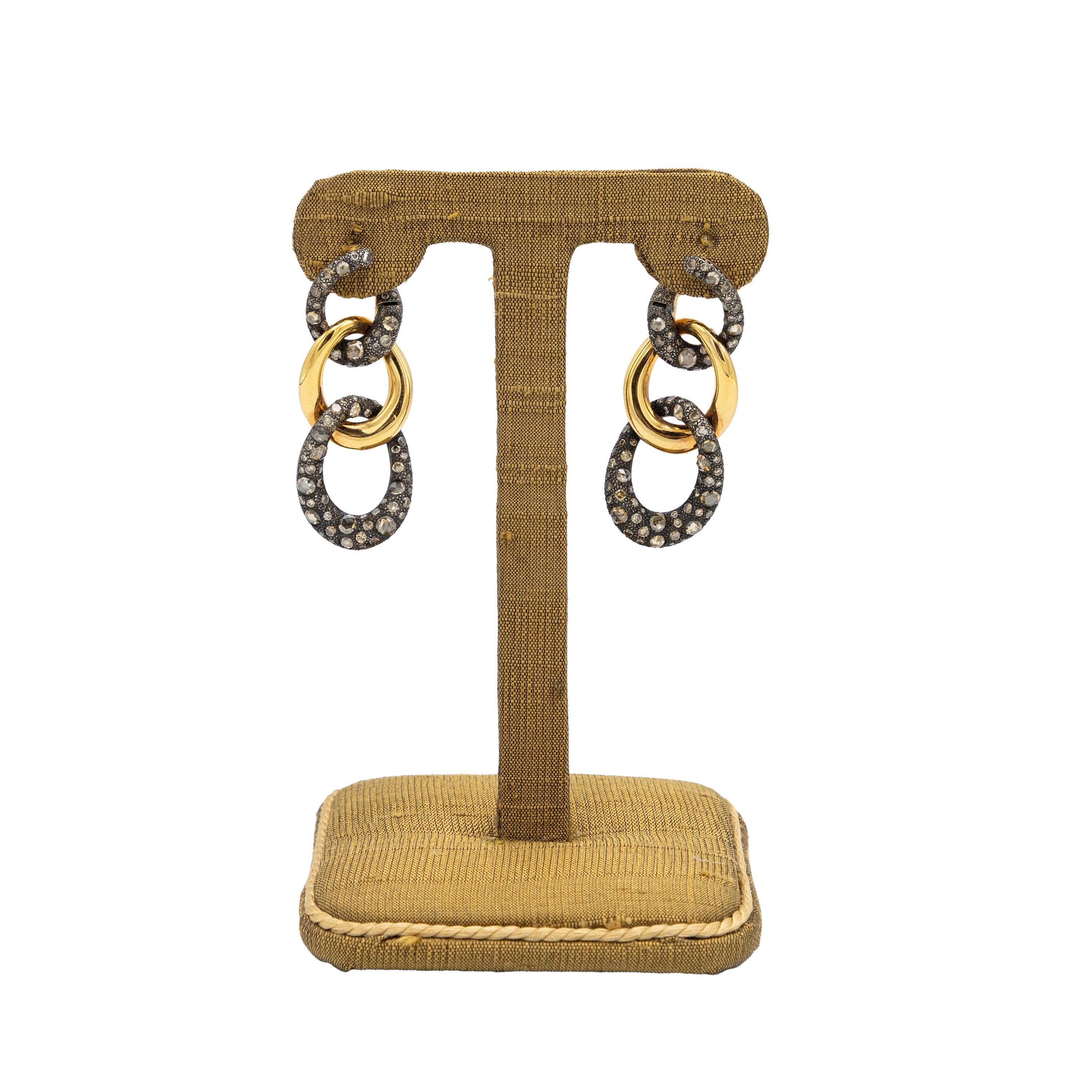 Pair of Maison Pomellato signature dangle earrings from “Tango” collecaratsion in 750/000 rose gold and burnished 925/000 sterling silver. Each is composed of 3 cord links, two of which are set with brown and pink brilliant-cut diamonds. 
 Retail