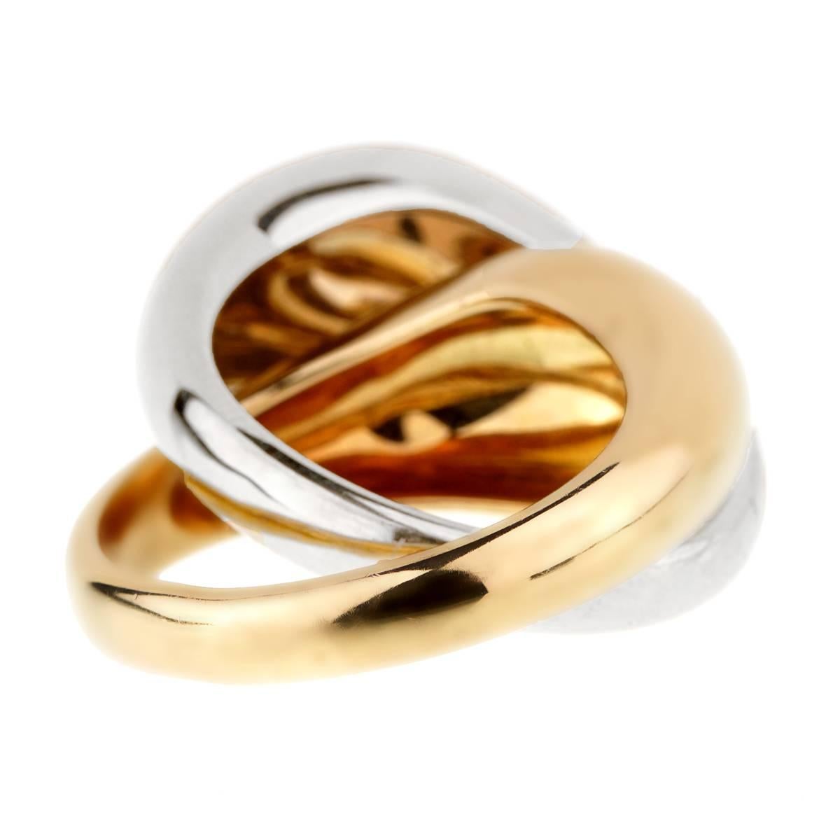 A stunning Pomellato ring featuring an interwoven design of 1 yellow gold ring and 1 white gold ring.    Size 6 1/2 Resizeable

Sku: 913
