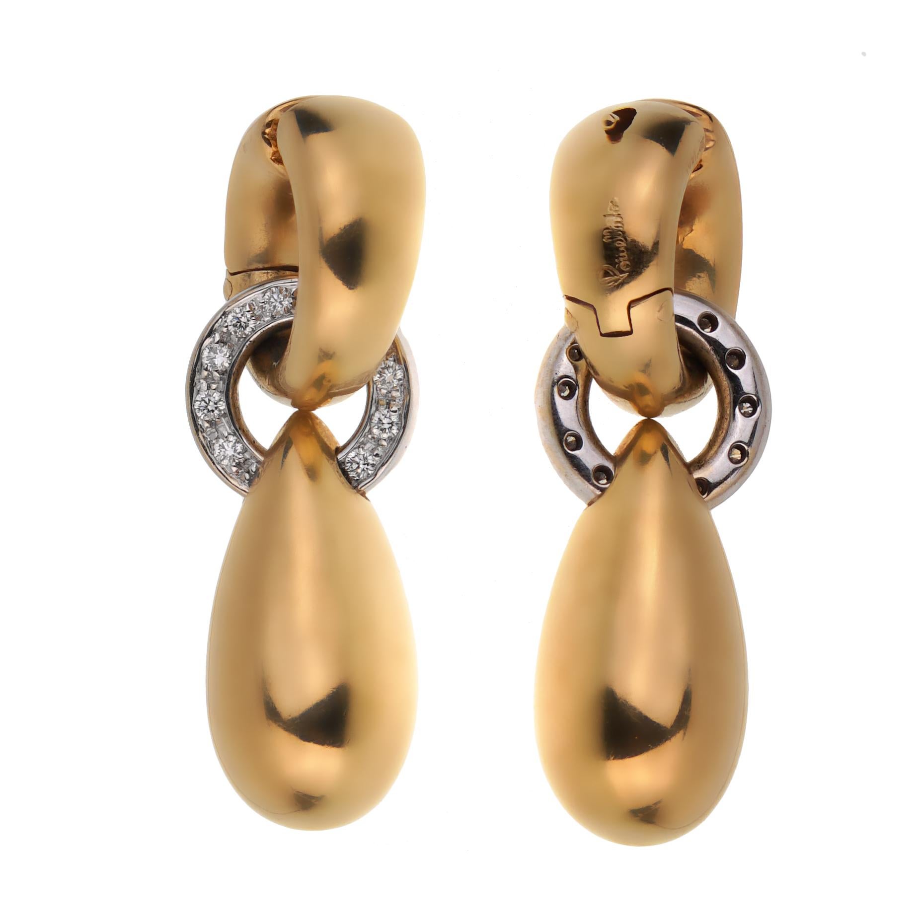 A chic set of Pomellato earrings showcasing round brilliant cut diamonds in 18k white and yellow gold.