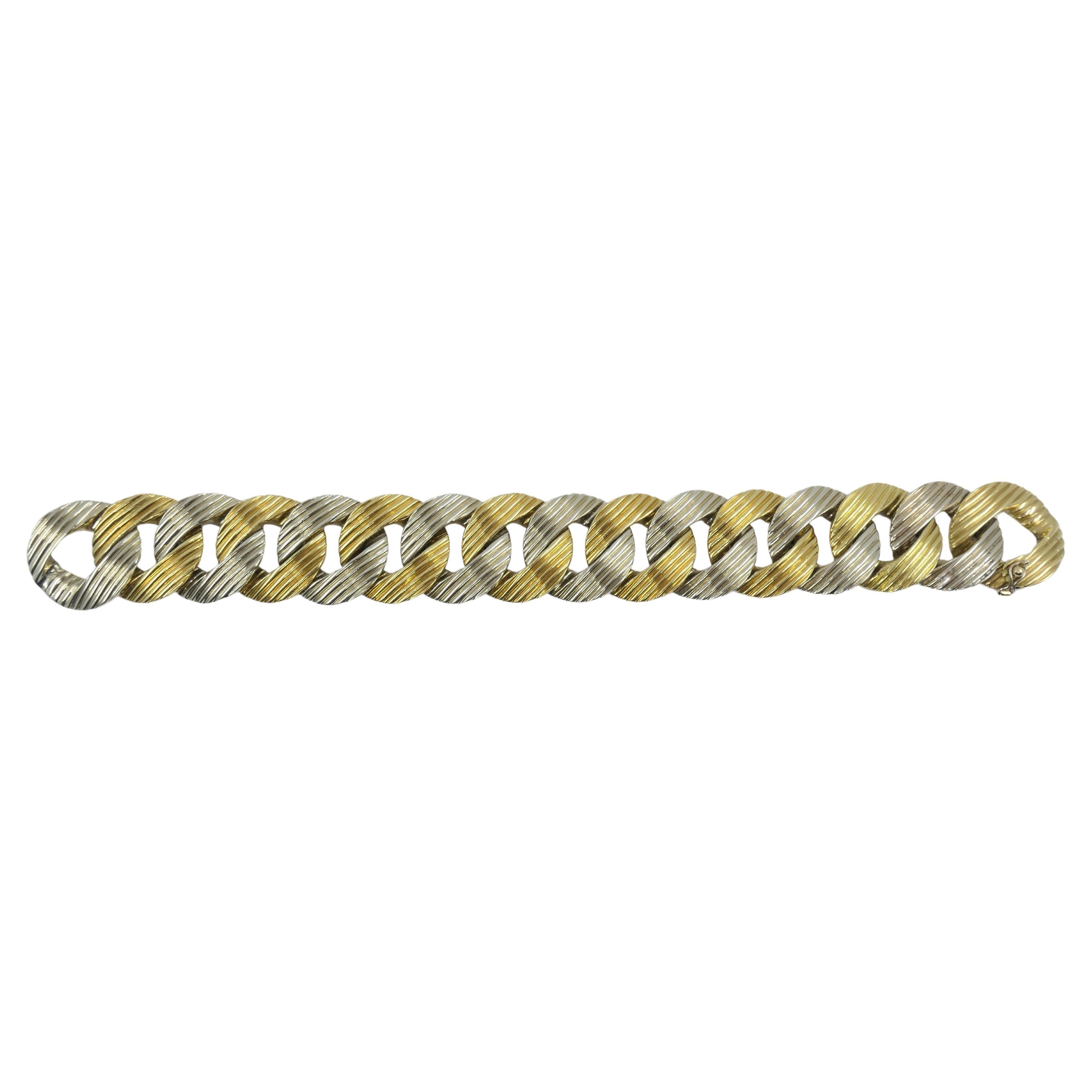 A chunky Pomellato bracelet made of 18k yellow and white gold. The links are greatly textured, which add even more significance to a substantial look. To match the tone of the white gold, the yellow gold hue is subdued and not too bright or yellow.