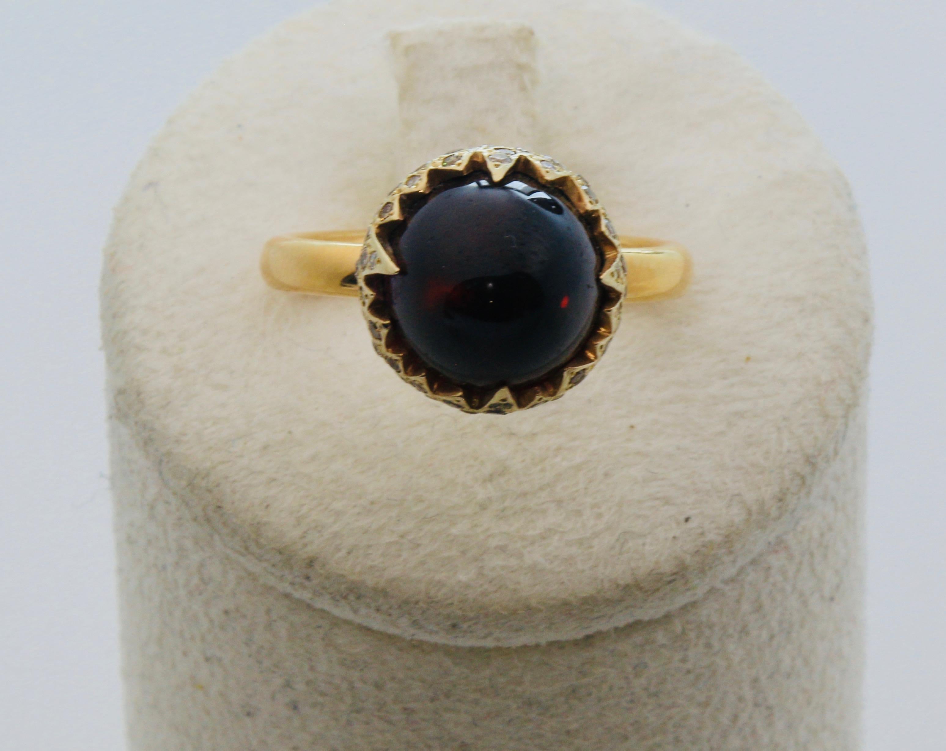 Pomellato Ring
Chimera collection
Material yellow gold 18k, Diamonds, Garnet stone Cabochon 
Weight 9,5 grams
Size US 5.75 - IT 11