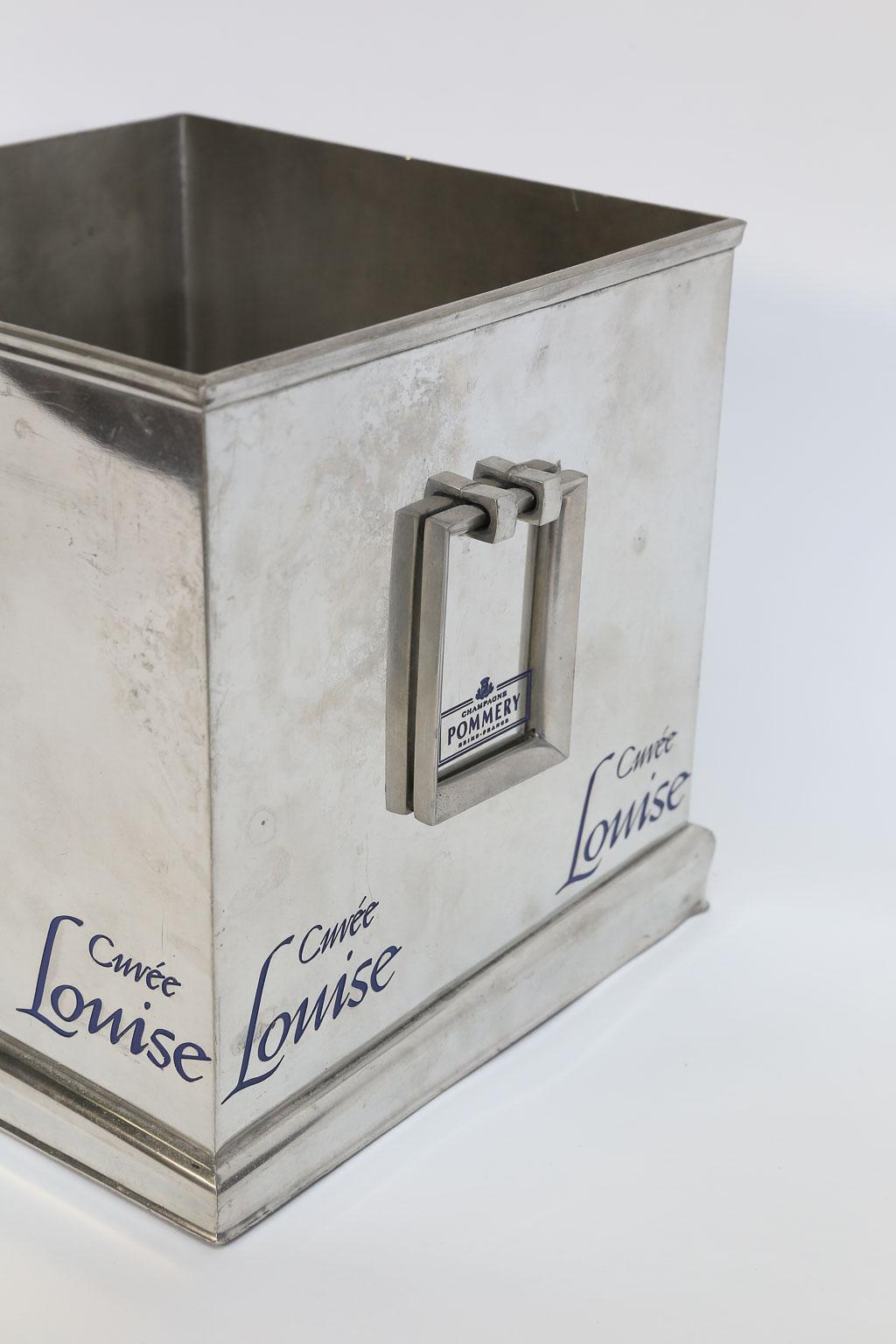 Made by the House of Pommery, this large champagne cooler is sure to delight. Square in shape, large in scale and having two rectangular handles, this wine cooler is unique. The cooler is embellished with the name Cuvee Louise, Pommery's wonderful