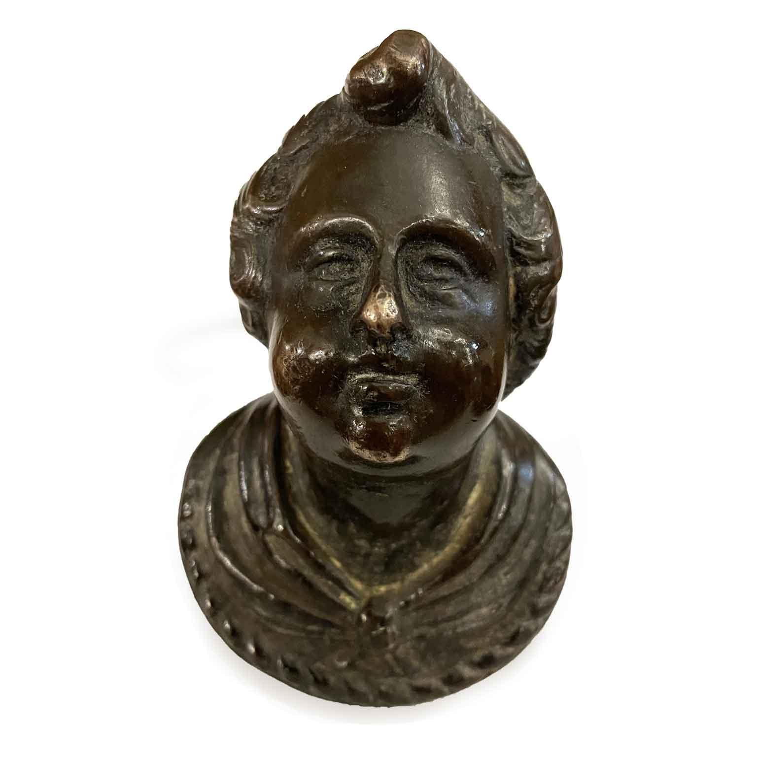 Bronze Bust Of 1600s, cast depicting a young boy with curly hair and a gathered robe over his neck ending in an oval section with beaded border.  This antique bronze knob of Italian origin in the shape of a human head was used as a handle in period