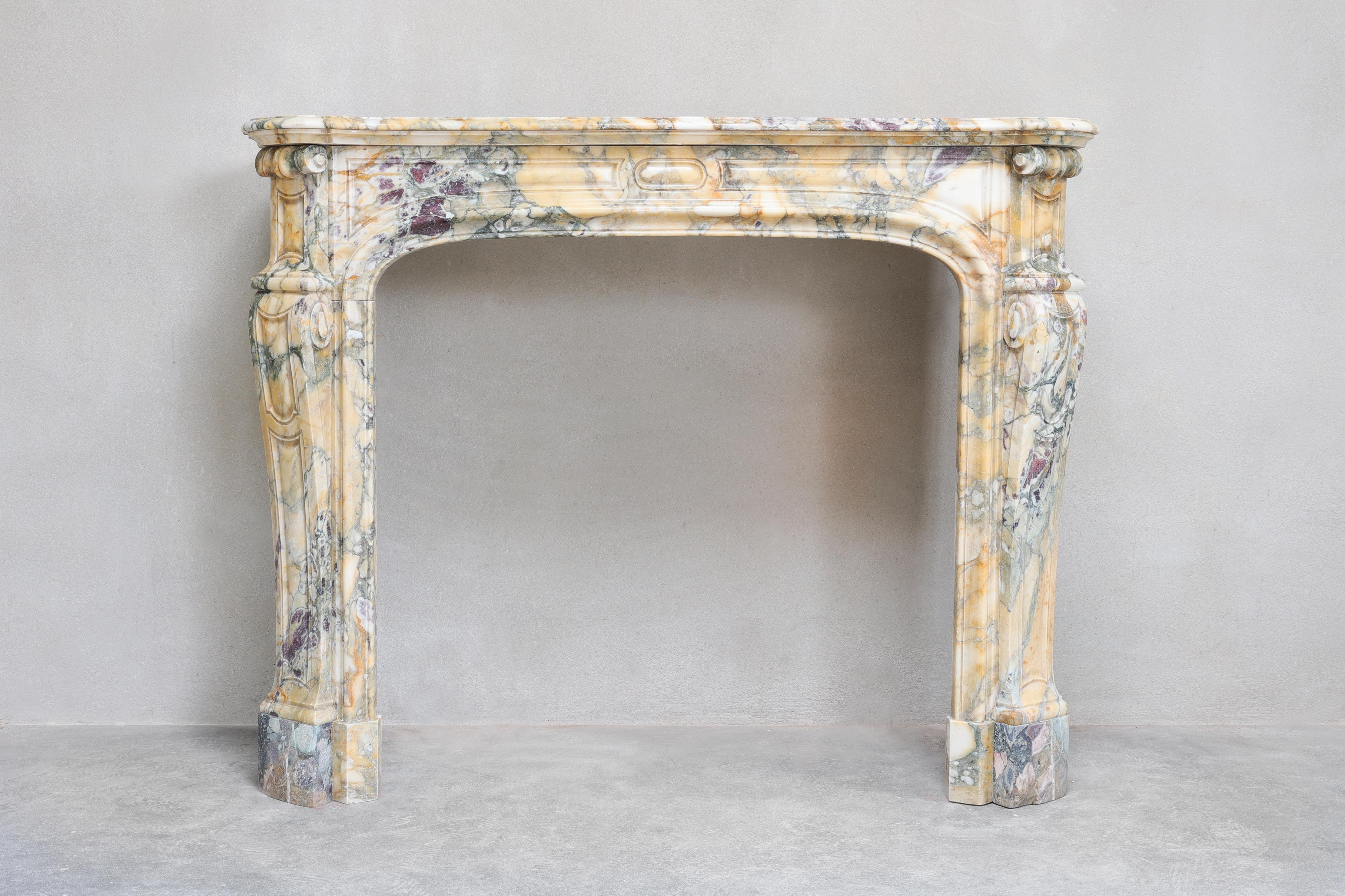 Very beautiful antique marble fireplace carved in  Brèche de Vendôme marble! This unique colourful marble has been extracted from the quarries in France! The merging of different types of stone creates a beautiful color scheme in both shape and