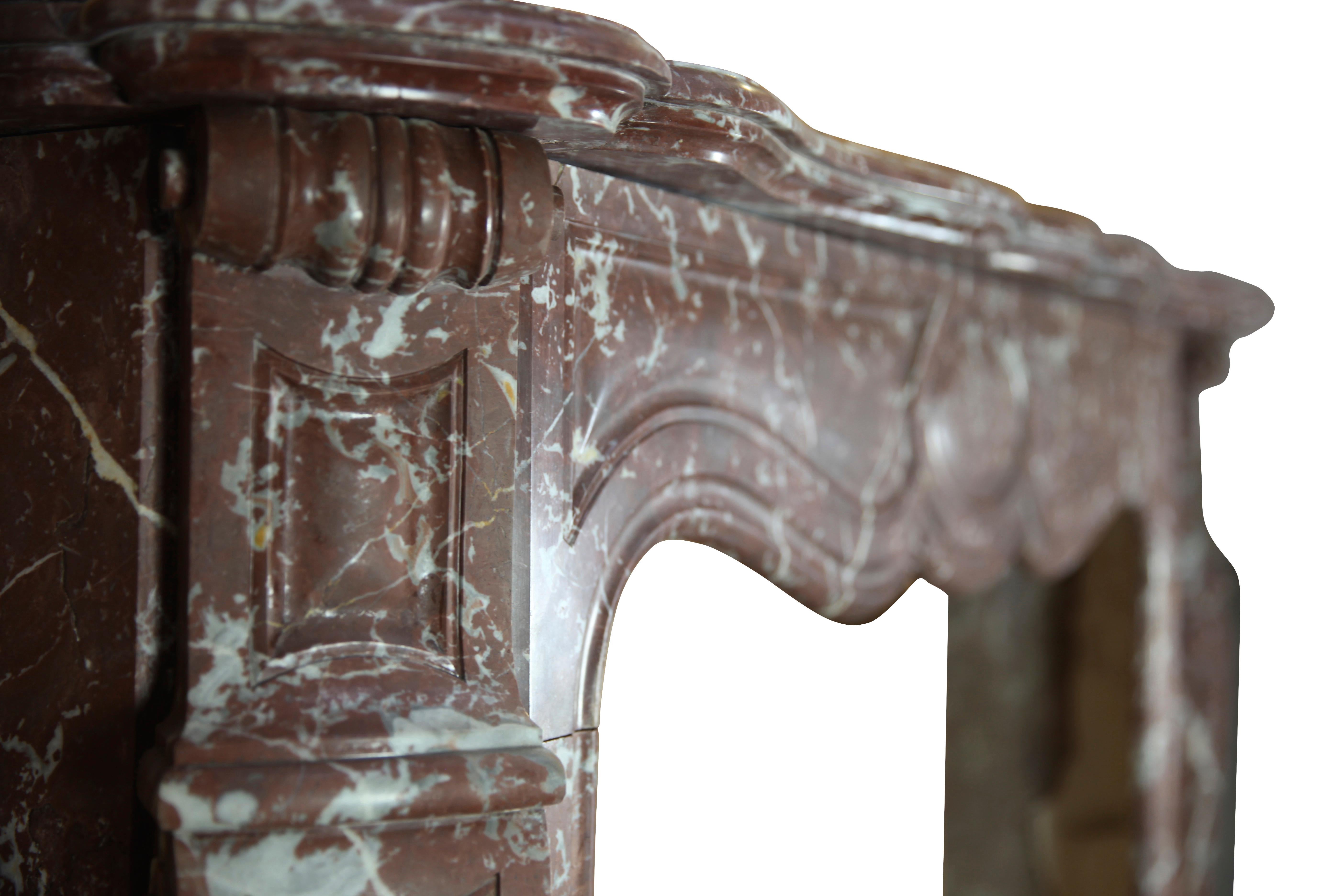 This fine Pompadour style vintage fireplace mantle has been made out of brown Belgian marble. It is from the 19th century and was installed in a Brussels apartment. 
Measures: 
142 cm Exterior Width 55,9 Inch
124 cm Exterior Hight 48,82 Inch
94