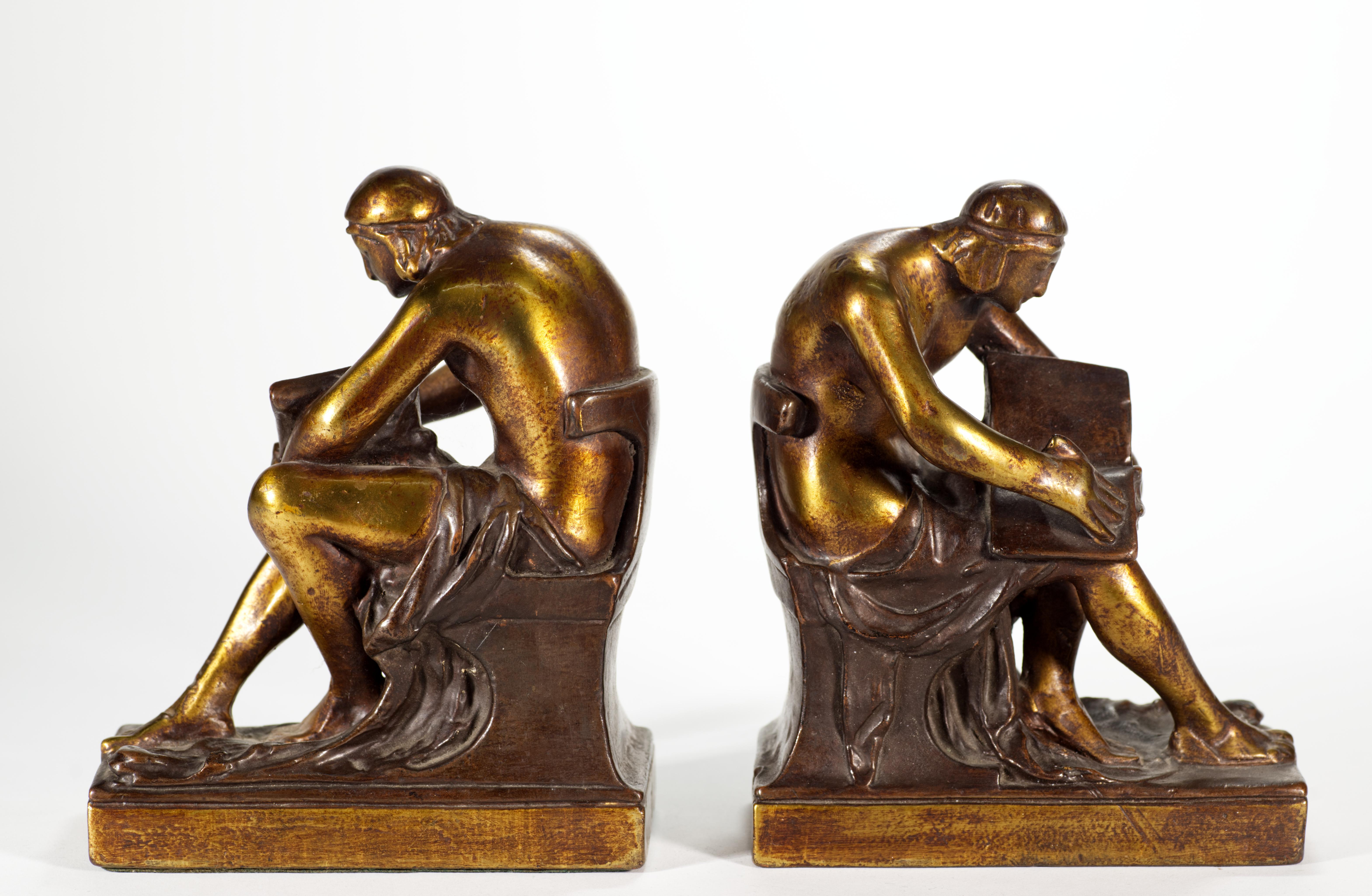  Heavy pair of vintage bronze plated bookends depict a seated scholar reading a book. The bookends are attributed to Pompeian Bronze Co, who were manufacturing this style of bookends in 1920s.

The bookends are in good vintage condition with